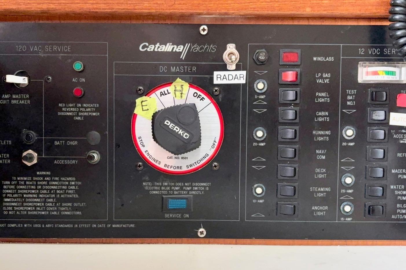 Control panel of a 1992 Catalina 34 yacht with various switches and indicators.