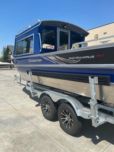 2025 Spartan 240 Maximus Pro boat on trailer, blue and silver design.