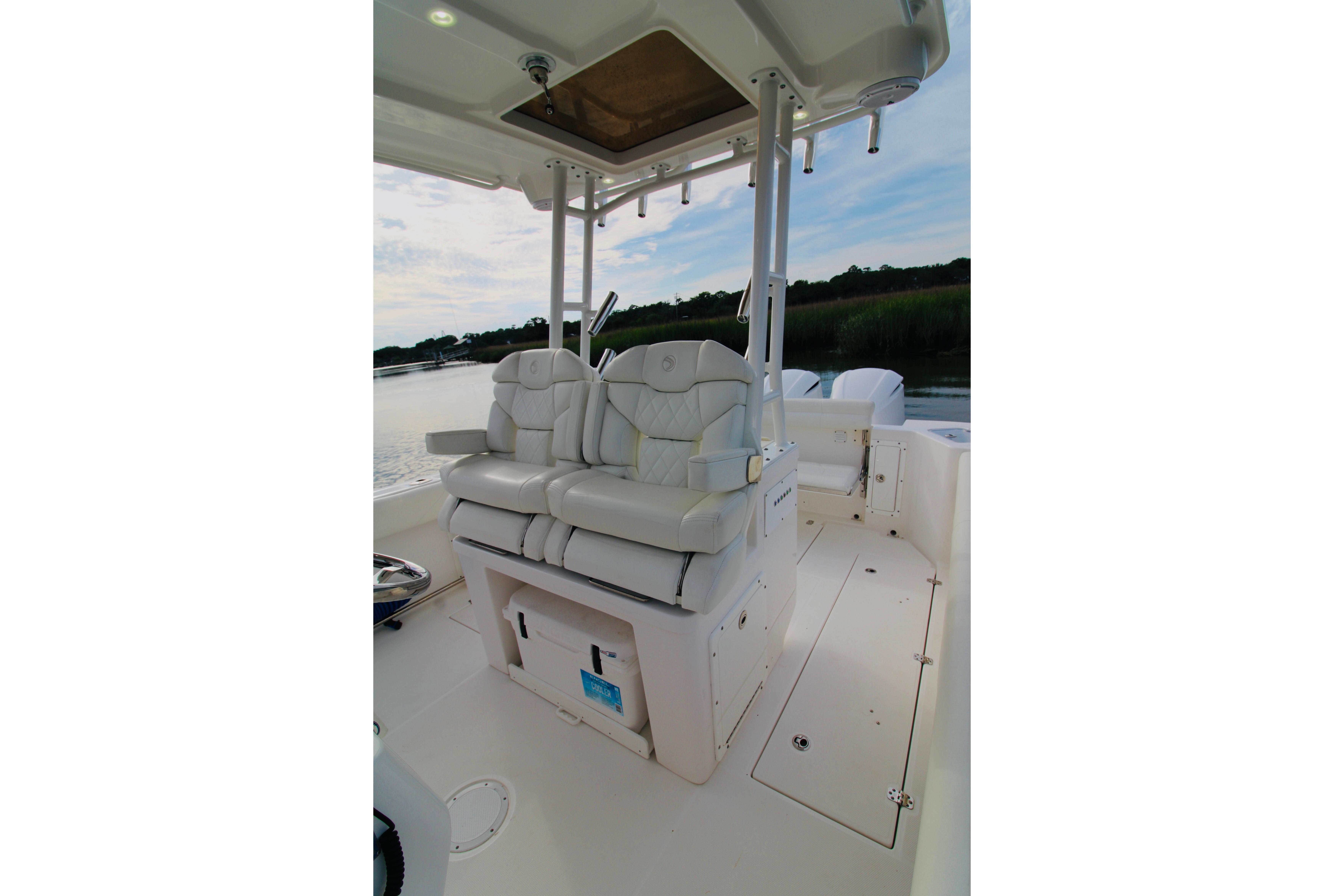 2022 Edgewater 280CC boat interior with dual white cushioned seats and sleek design.