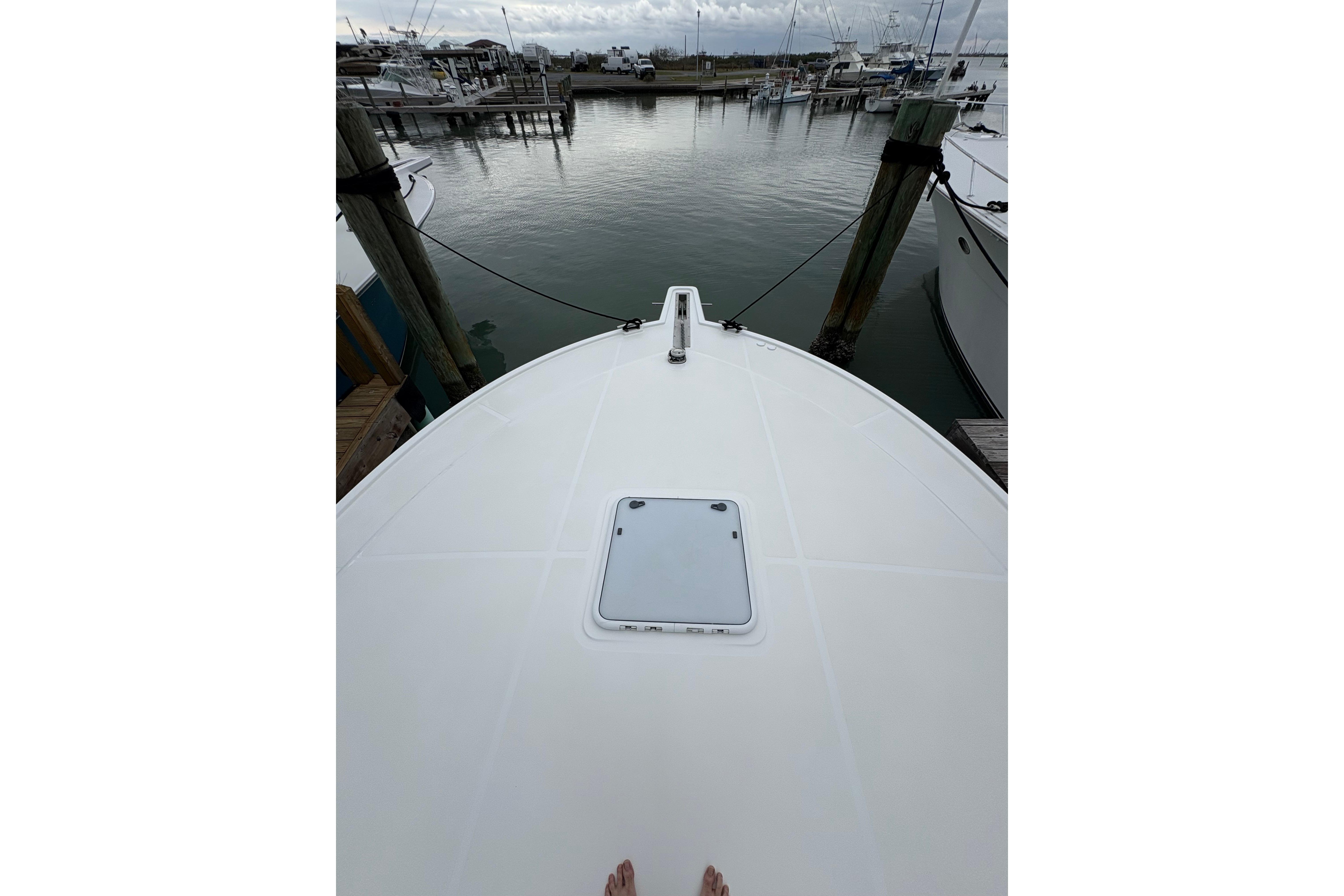 Bow view of 2004 Cabo 40 Hardtop Express docked at marina.