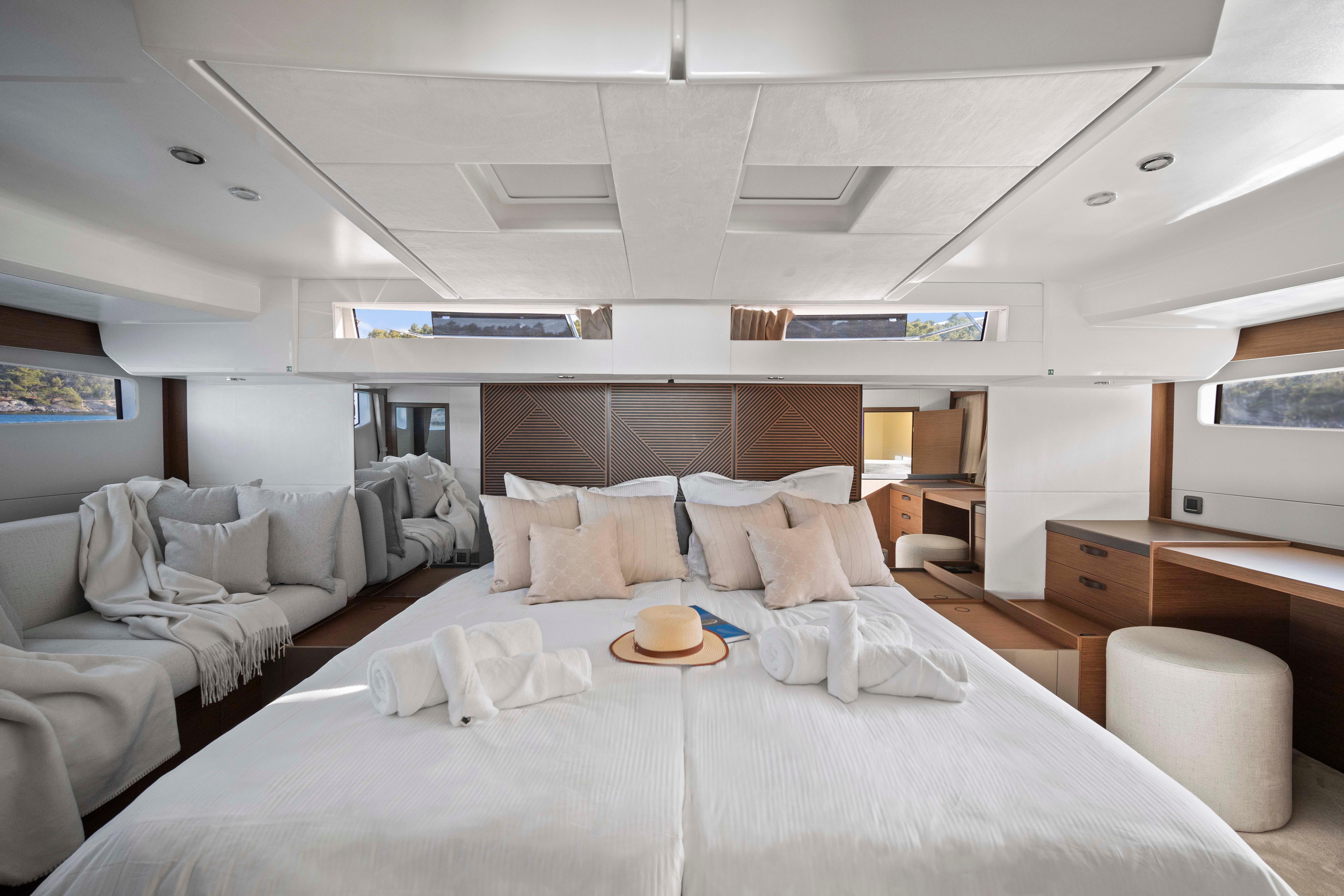 Luxurious interior of 2024 Prestige M48 yacht with elegant bedding and modern furnishings.