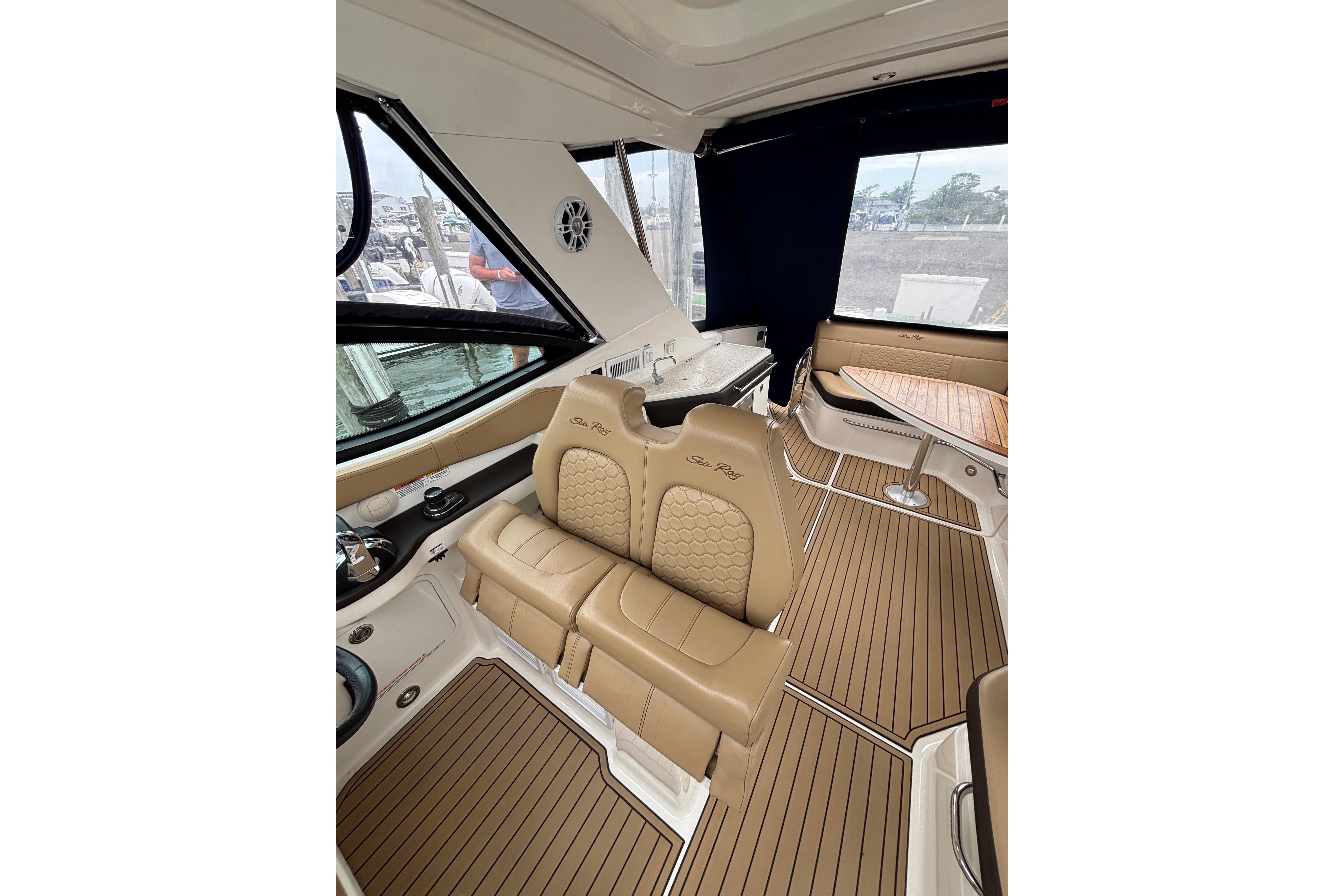 2021 Sea Ray Sundancer 320 Outboard interior with tan seating and wood flooring.