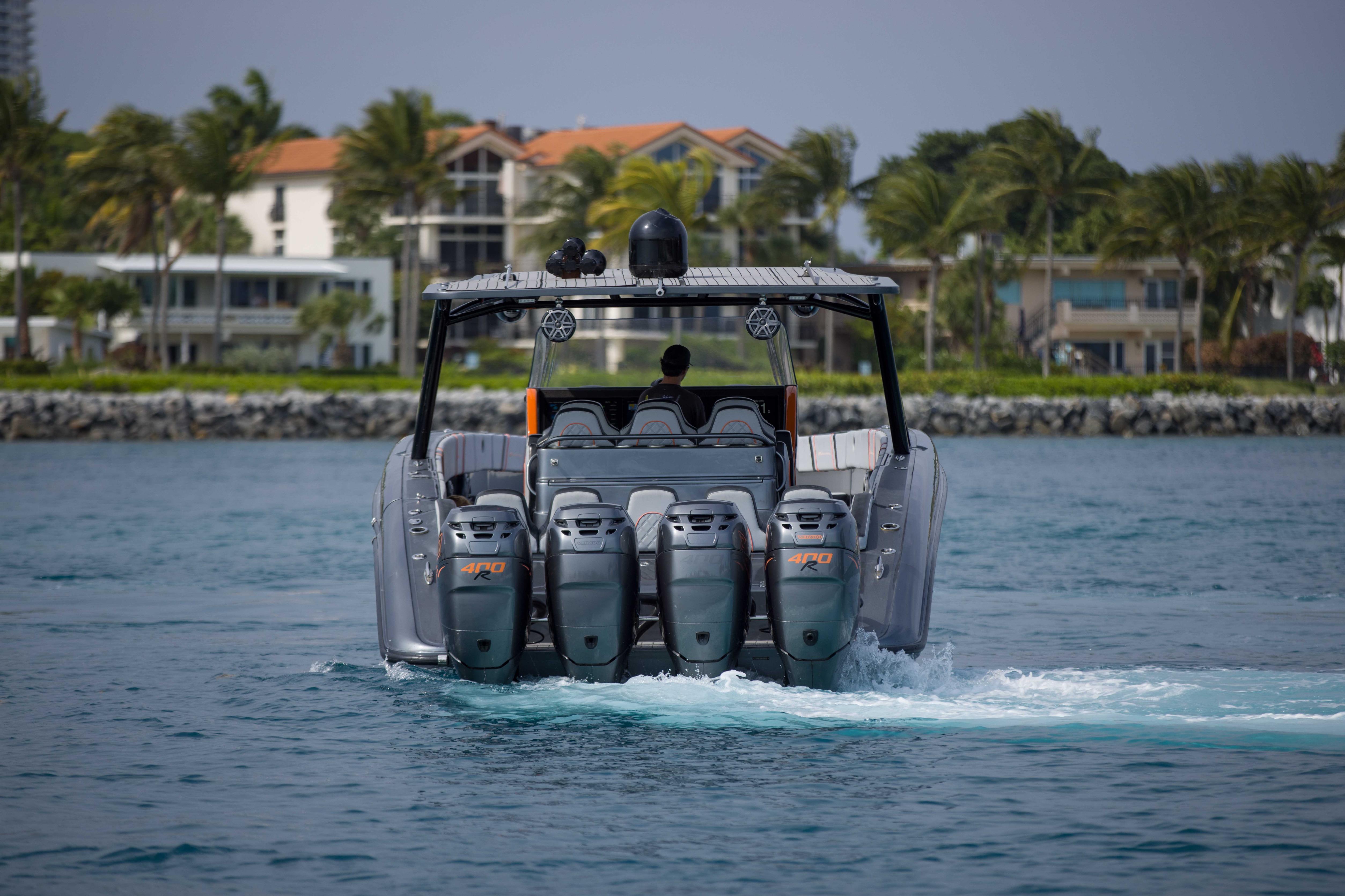 2019 Midnight Express 43 Open boat cruising near coastal homes with four powerful engines.