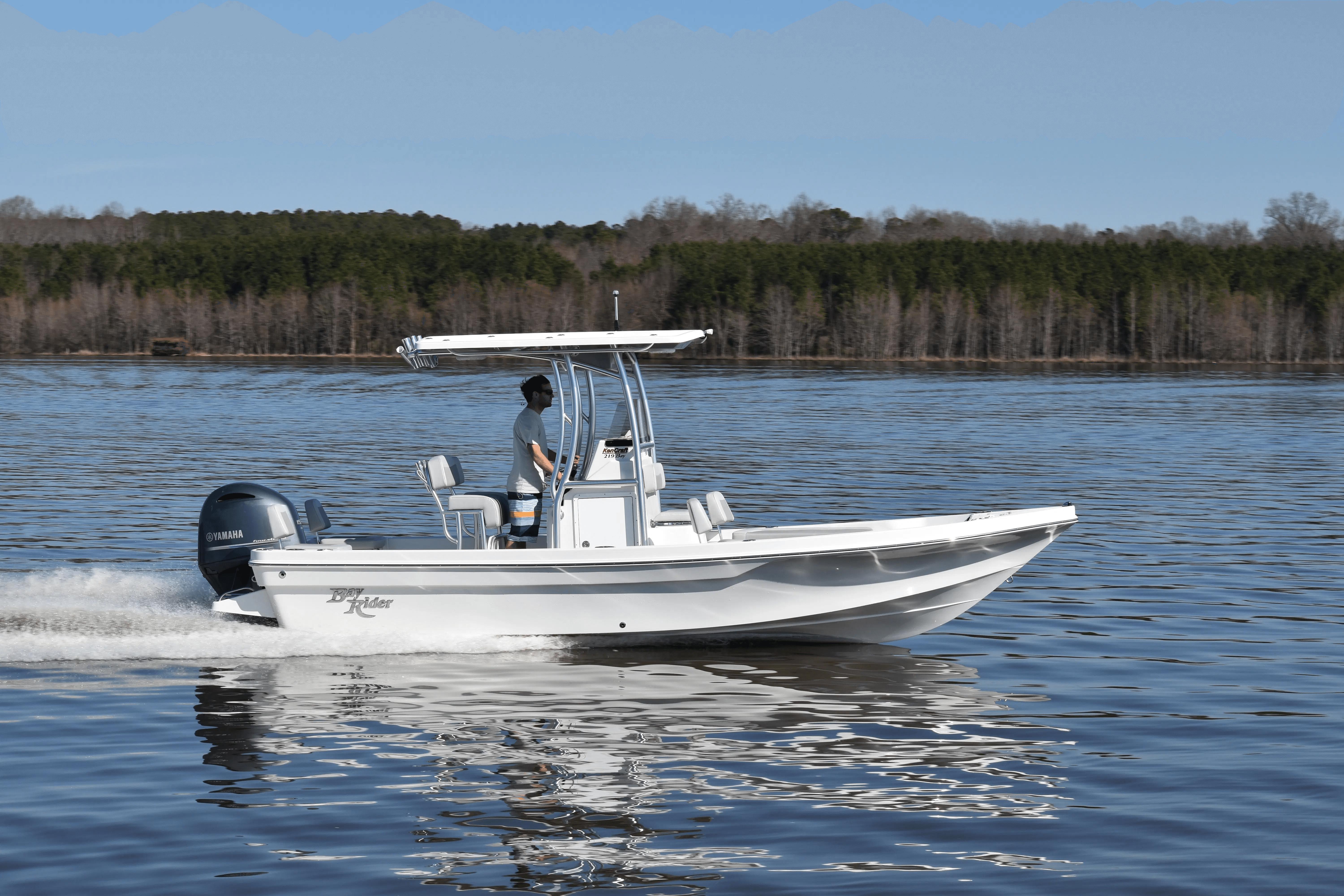 2024 KenCraft 219 Bay Rider Bay boat cruising on a calm lake.