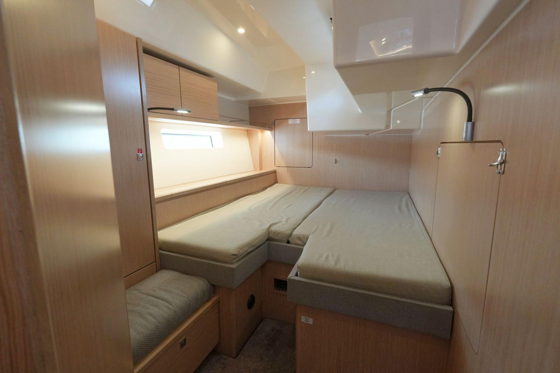 Luxurious interior cabin of 2018 Bavaria C57 Style yacht with modern wood finish.