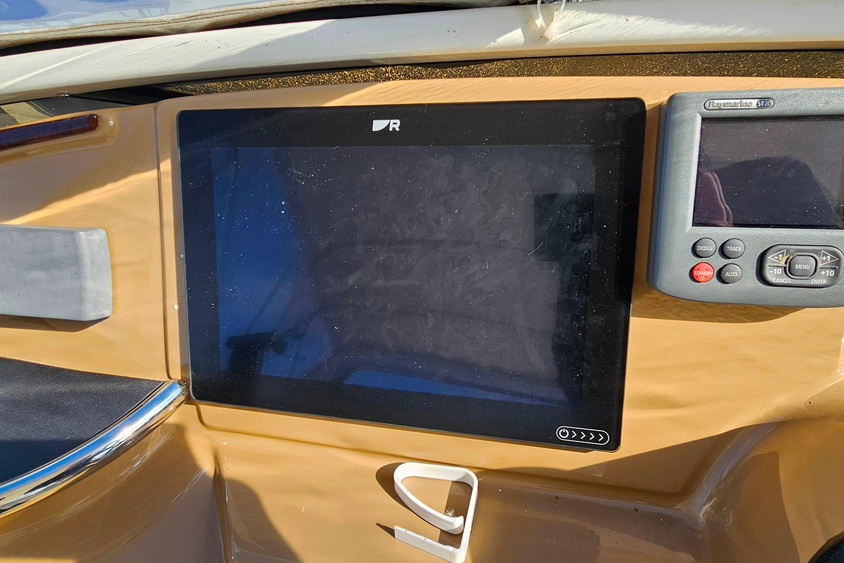 Dashboard of 2004 Carver 444 Cockpit Motor Yacht with navigation screens.