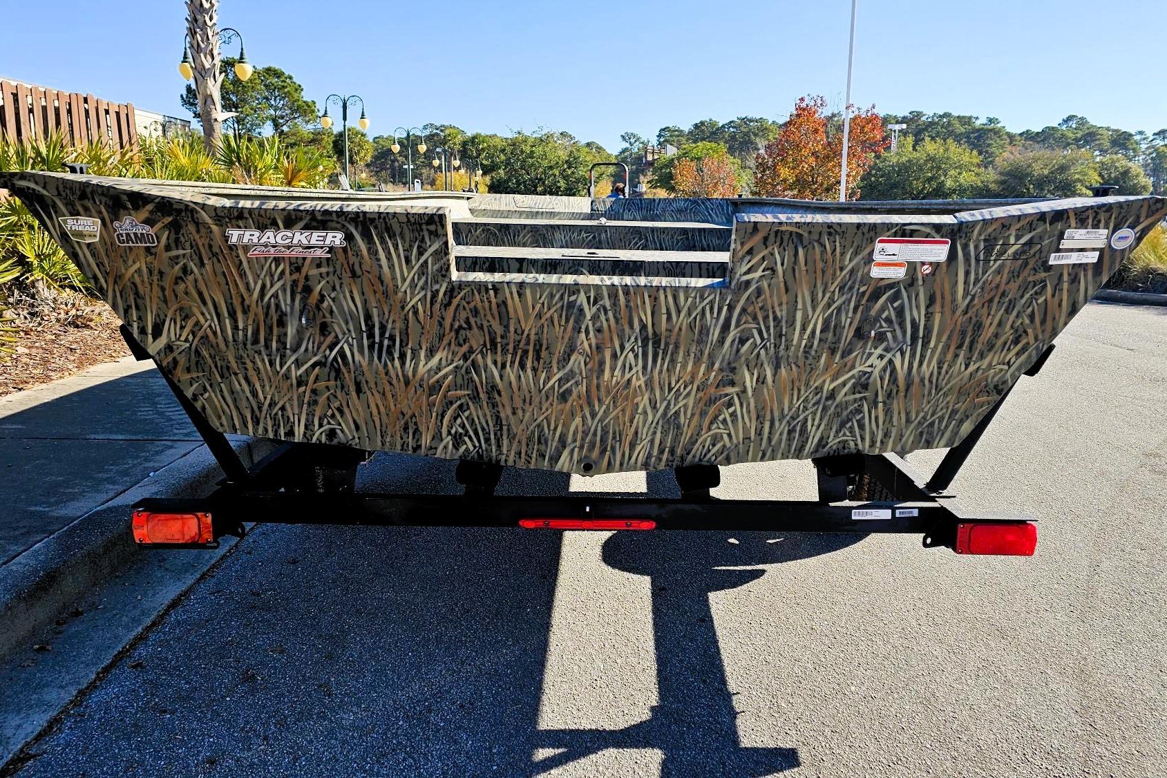 2026 Tracker Grizzly 2072 Utility boat with camo design on a trailer.