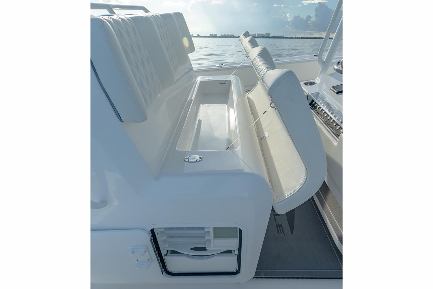 Manufacturer Provided Image: 2026 Invincible 33 Catamaran interior seating with storage, showcasing sleek design and functionality.