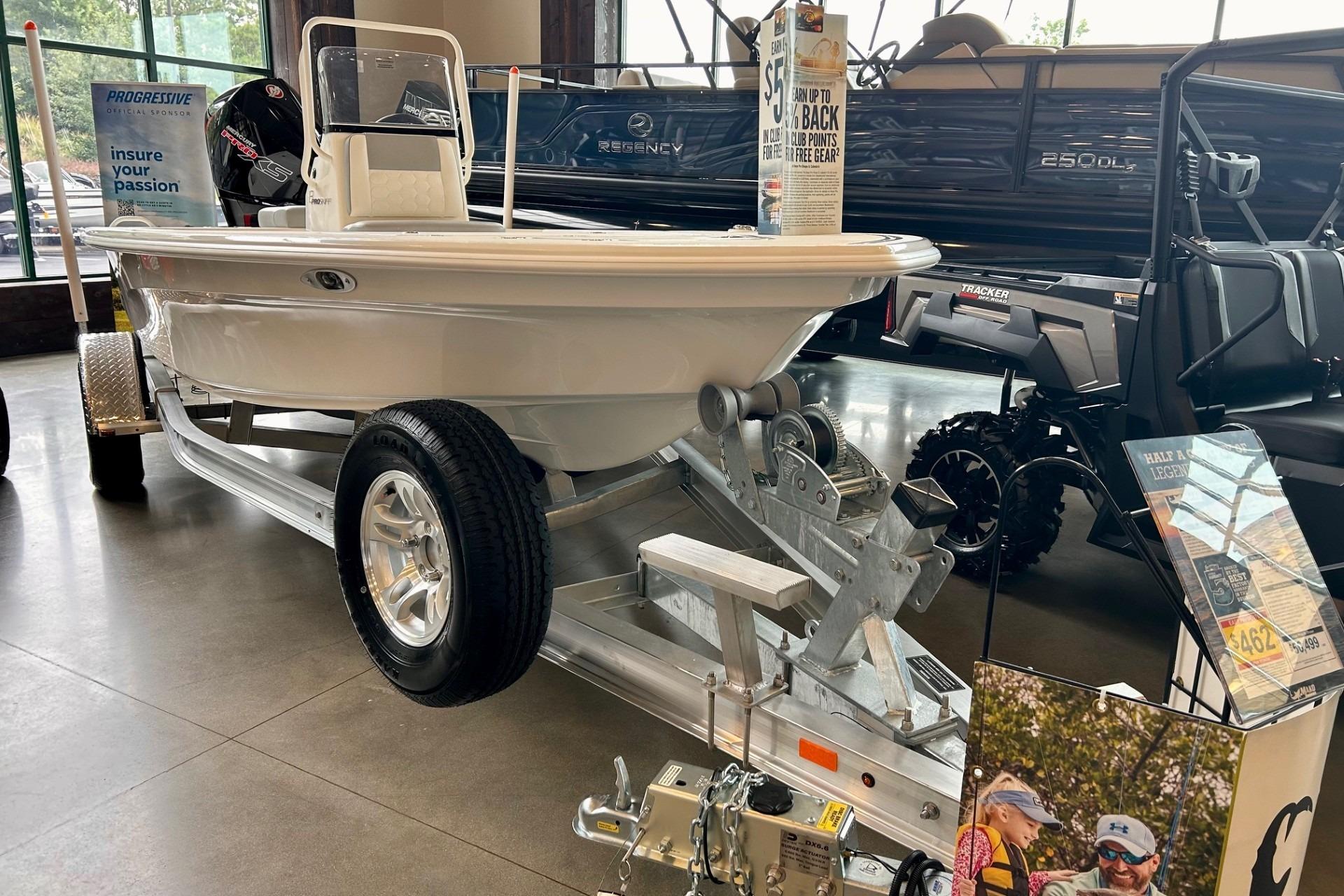 2026 Mako Pro Skiff 18 boat on display in showroom with trailer.