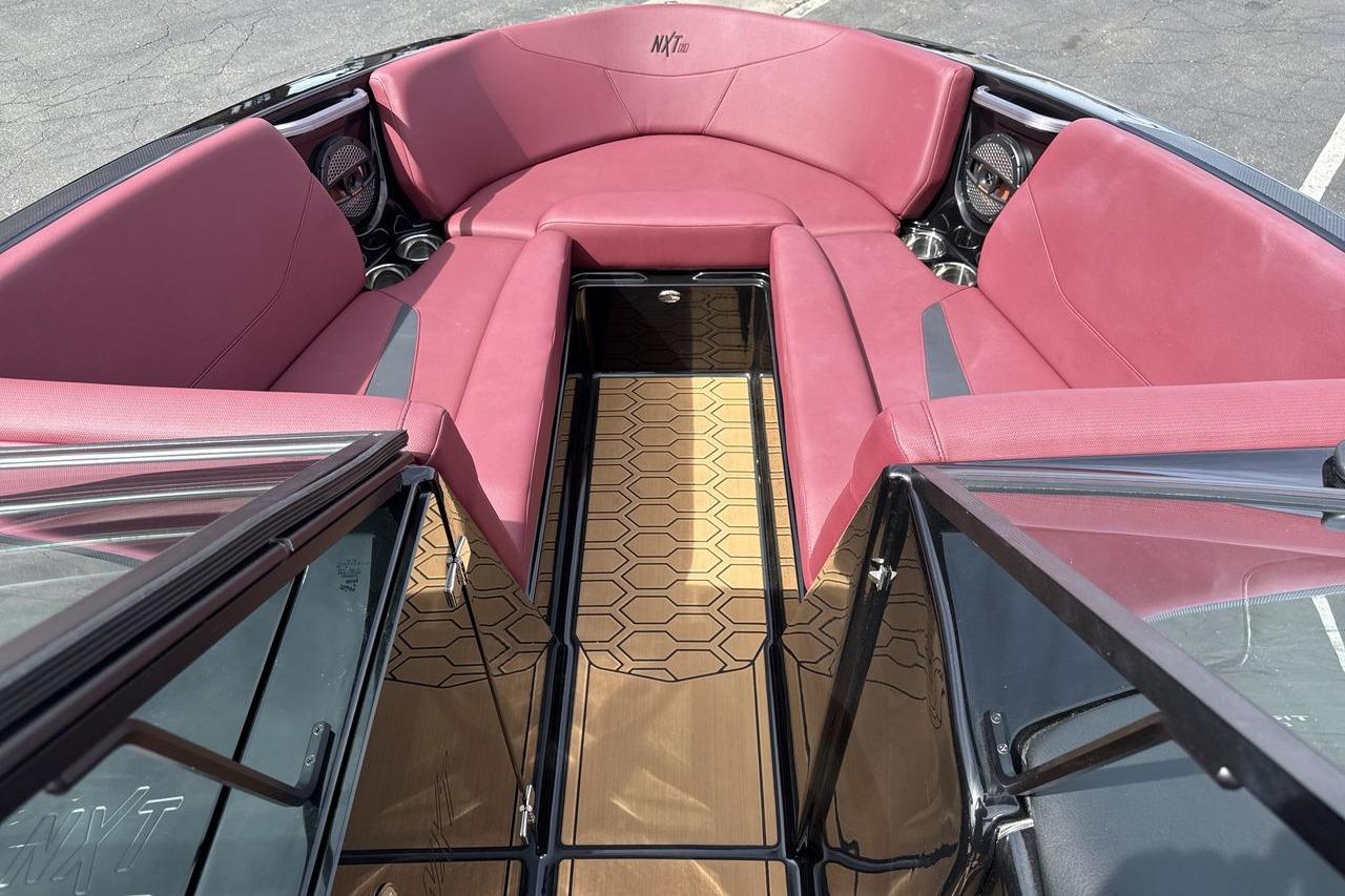 2023 MasterCraft NXT22 boat interior with pink seating and hexagonal floor design.