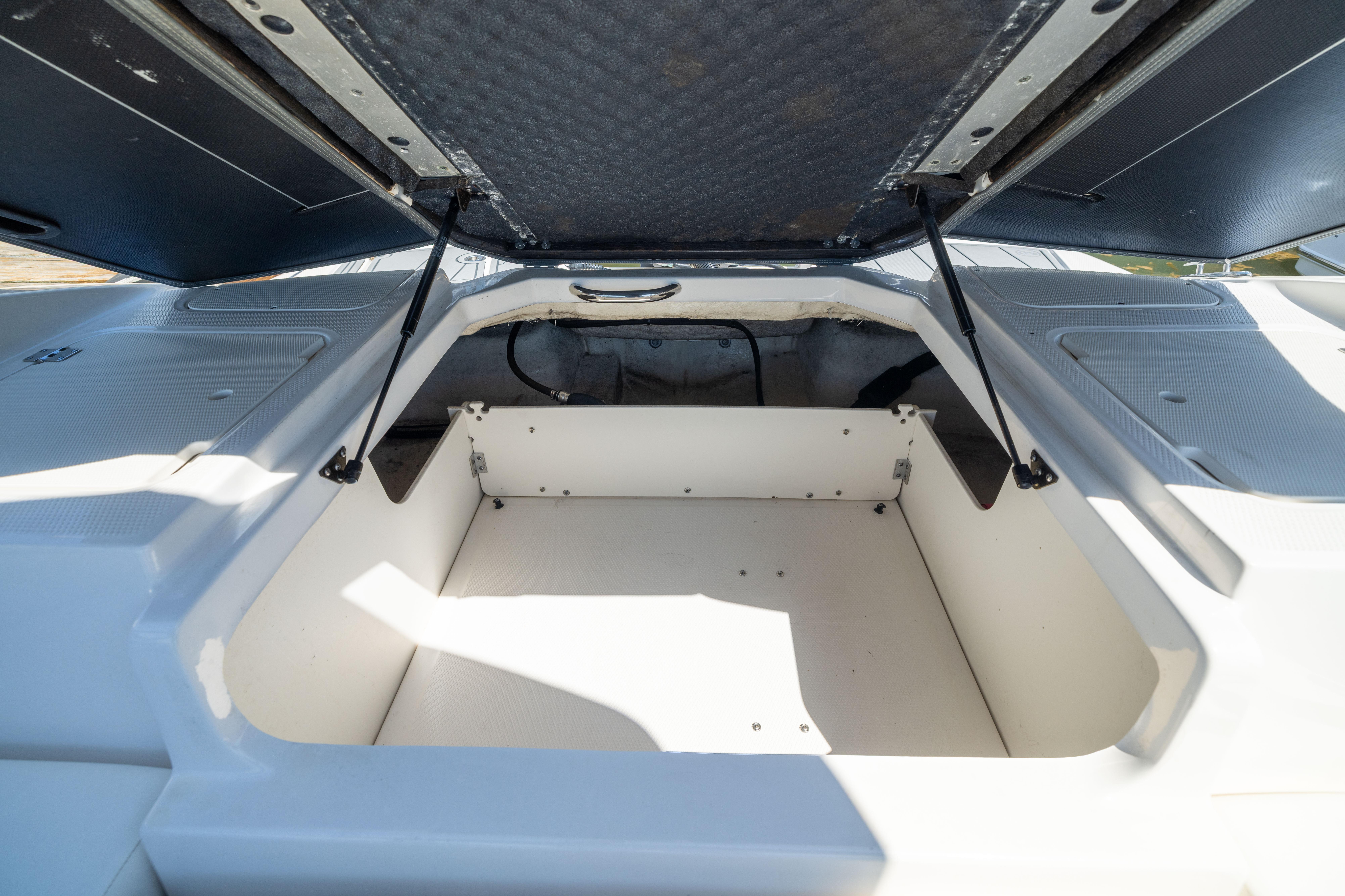 Open storage compartment on 2022 Chaparral 21 SSi OB boat, showcasing spacious interior.