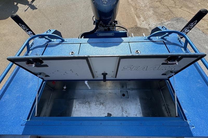 2026 SeaArk Dynasty 2.0 boat with open storage compartment, blue exterior, and visible motor.