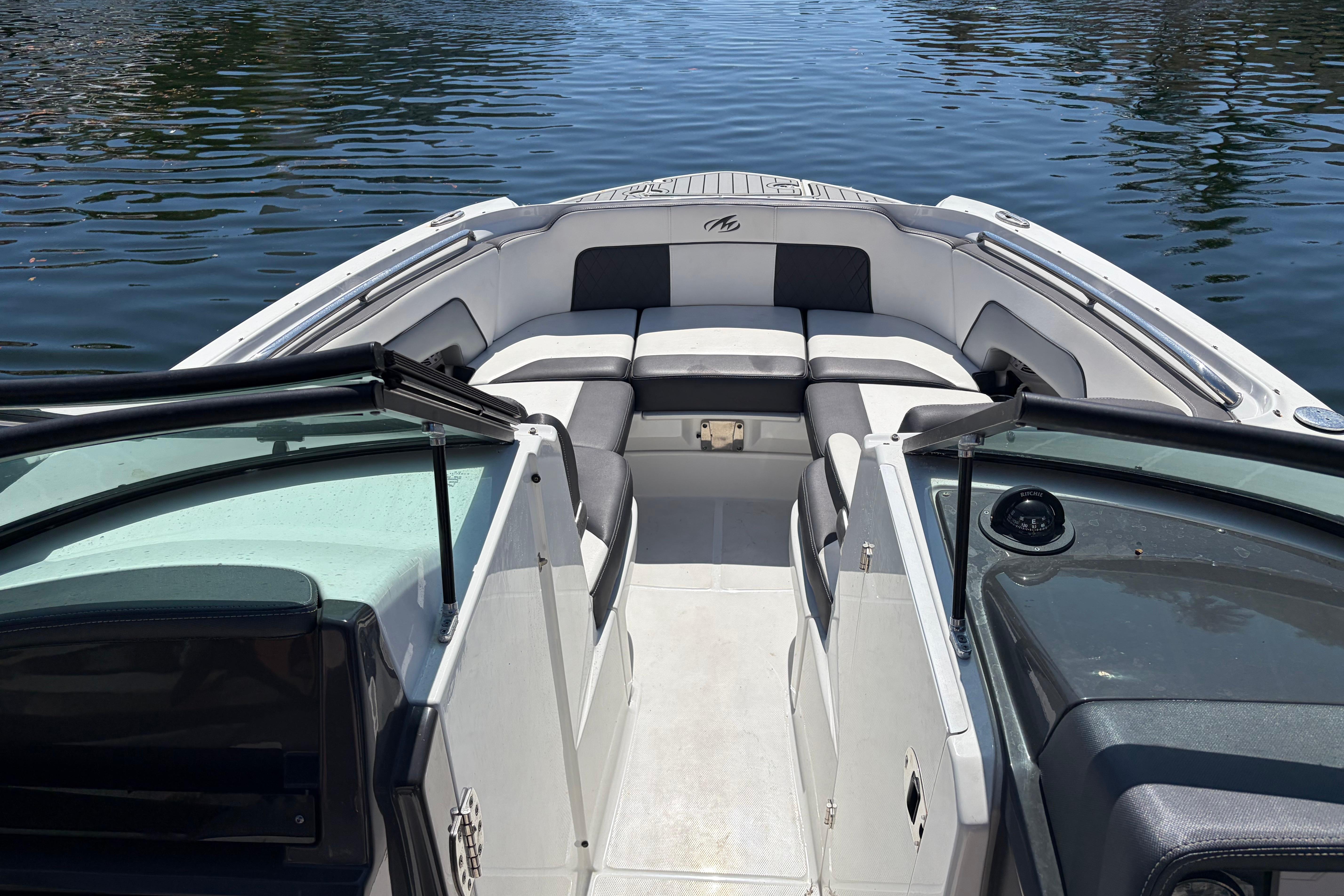 2022 Monterey M-65 boat interior with seating, open deck, and water view.