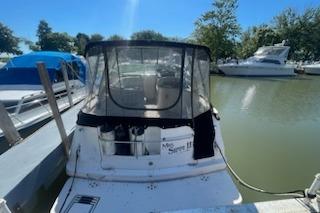 2000 Rinker Fiesta Vee 310 docked at a marina on a sunny day.