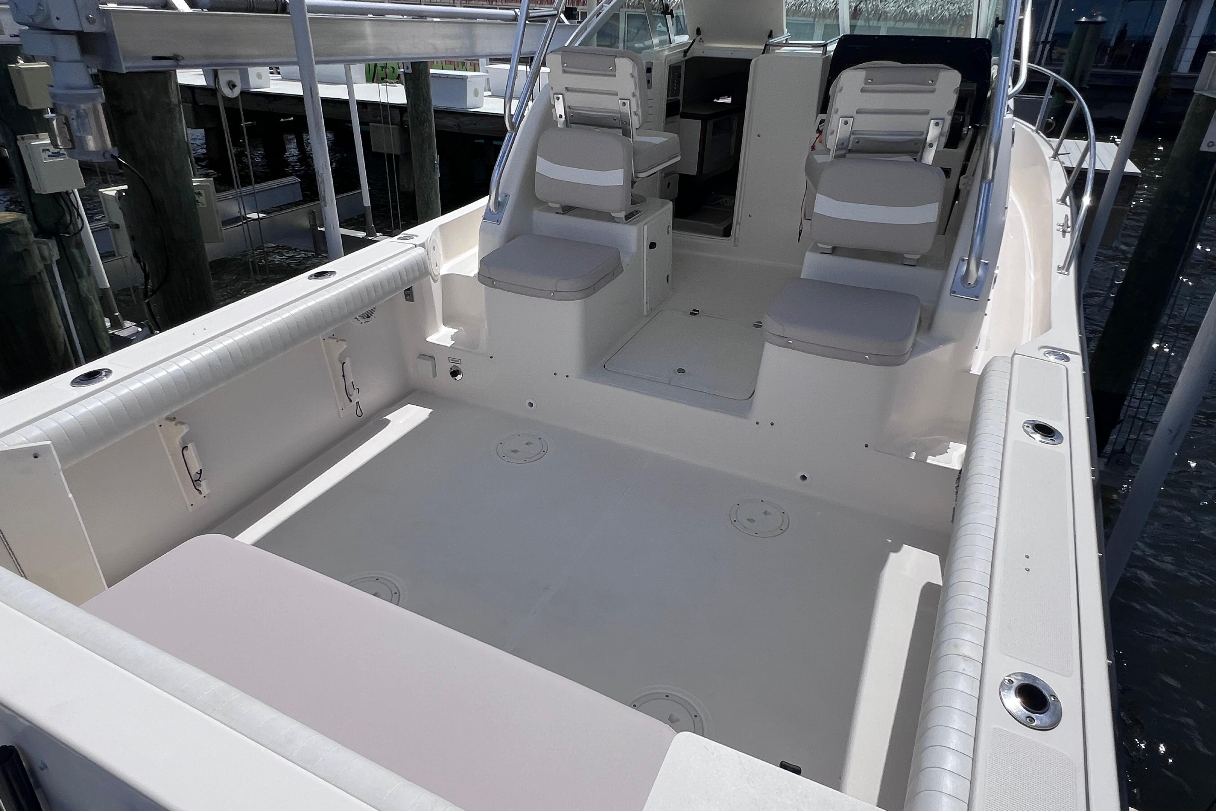 2004 Pursuit 2870 Walkaround boat interior with seating and spacious deck area.