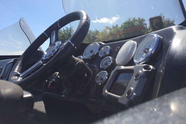 Close-up of 2020 Nitro ZV21 boat dashboard with steering wheel and gauges.