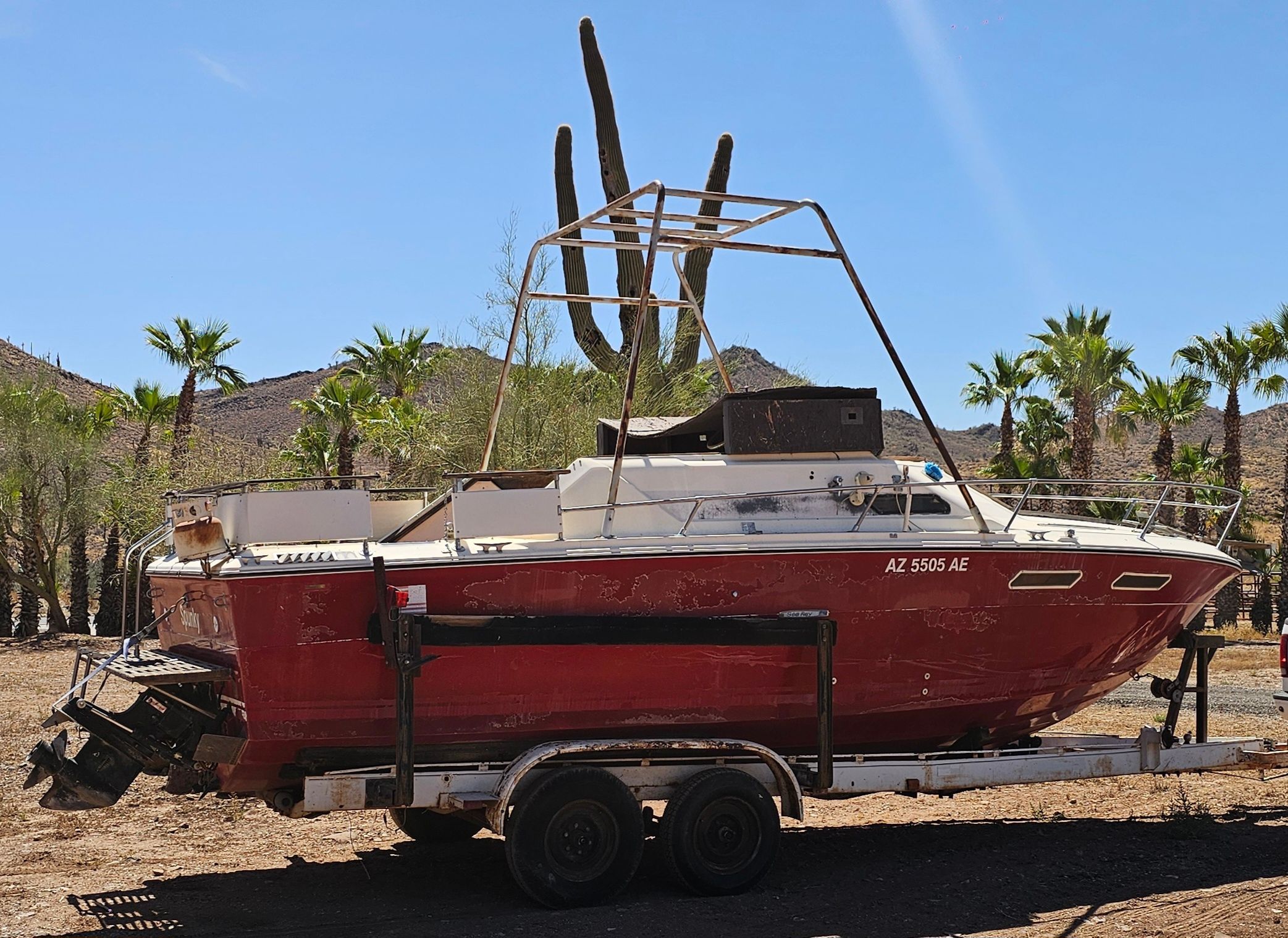 1975 Sea Ray Cabin Cruiser on trailer in desert landscape.