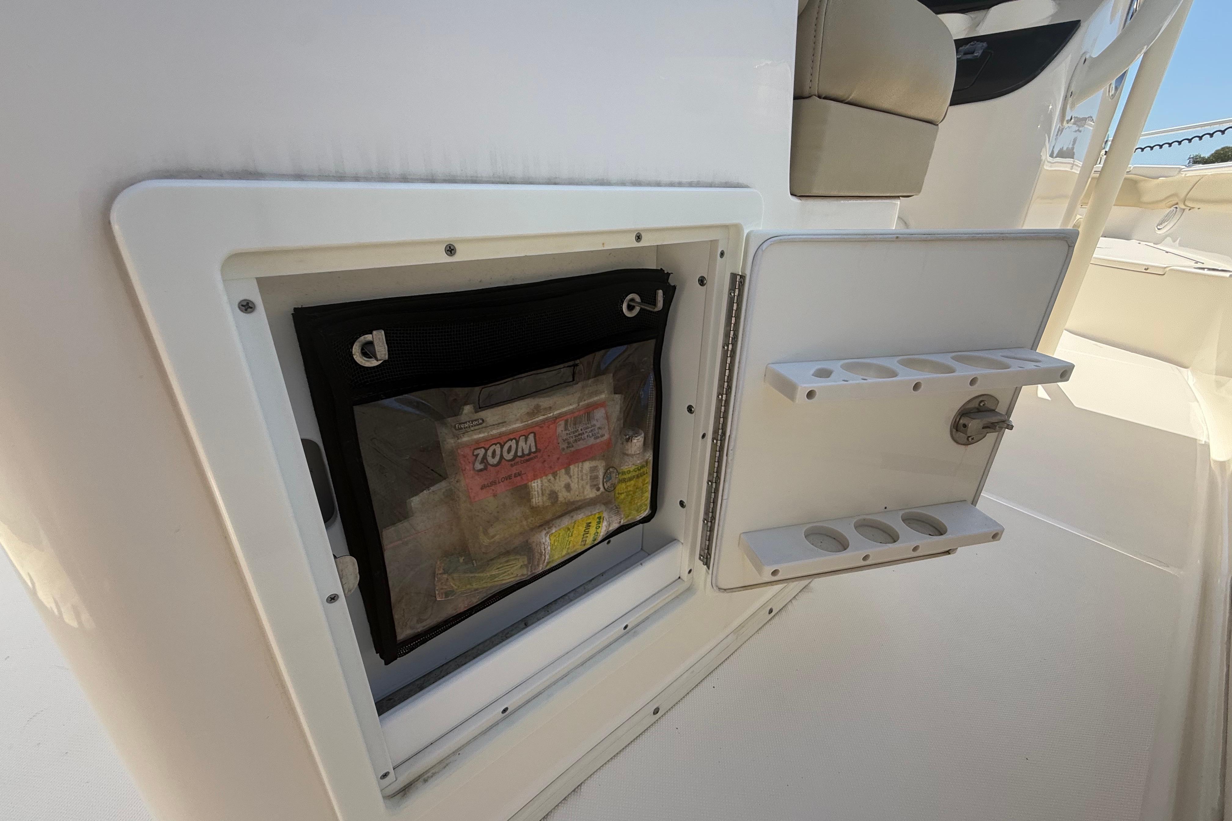 2019 Key West Billistic 281 Center Console storage compartment with open hatch and tackle storage.