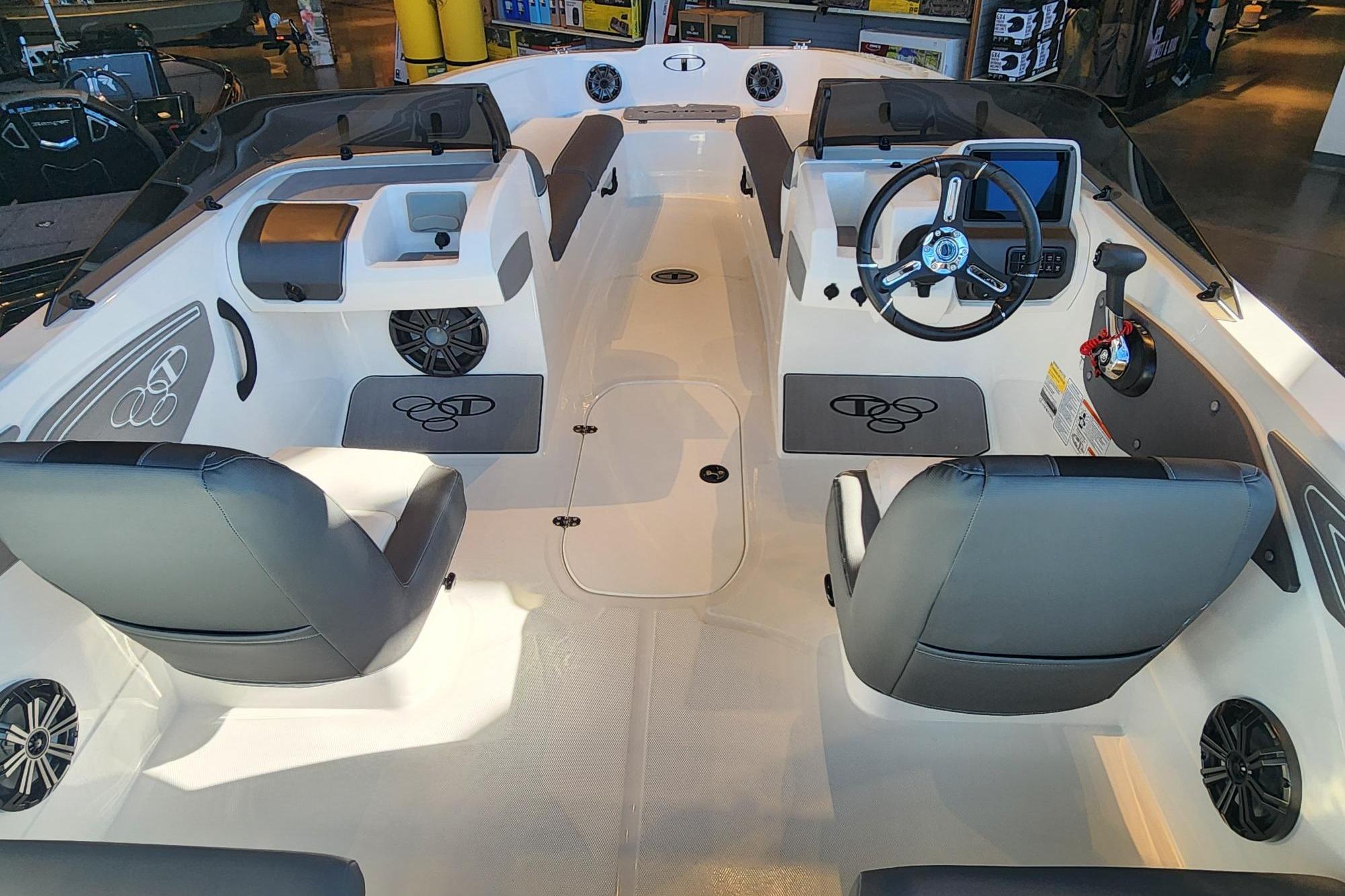 Interior view of 2026 Tahoe T21 boat, featuring modern seating and steering console.