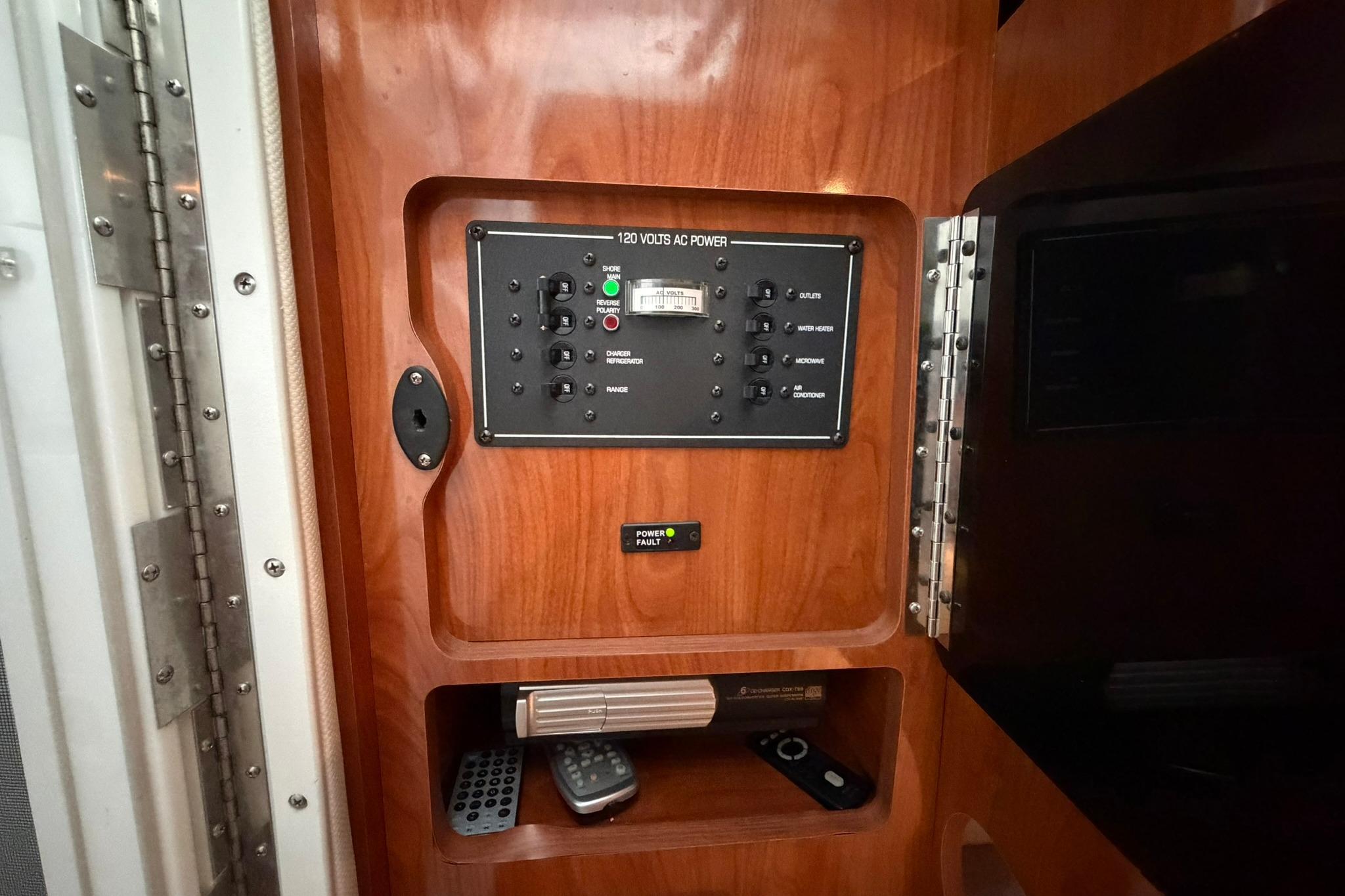 Control panel inside 2008 Four Winns V248 boat, featuring wood finish and electronic controls.
