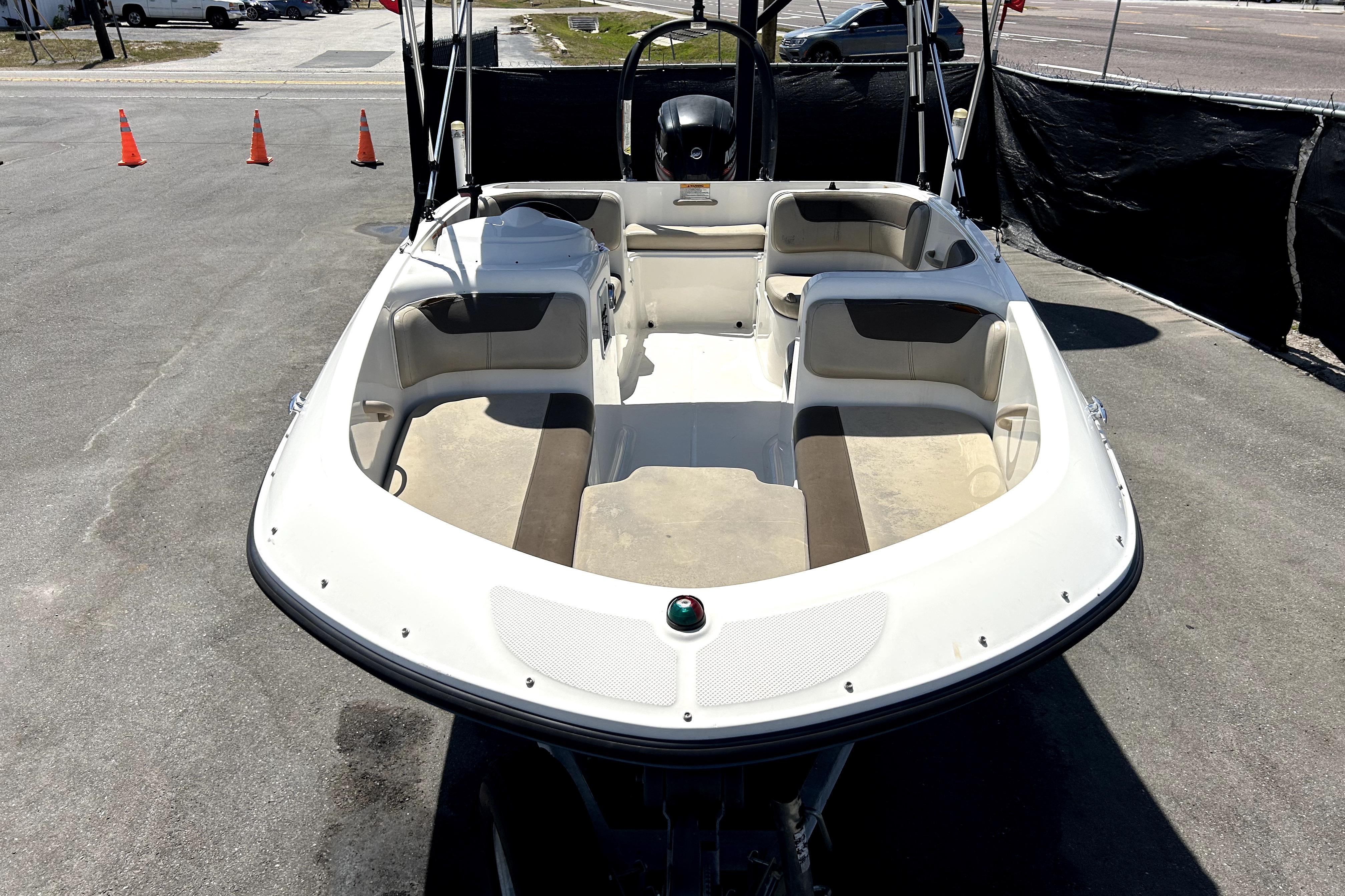 2017 Bayliner Element E16 boat with spacious seating, parked on pavement.