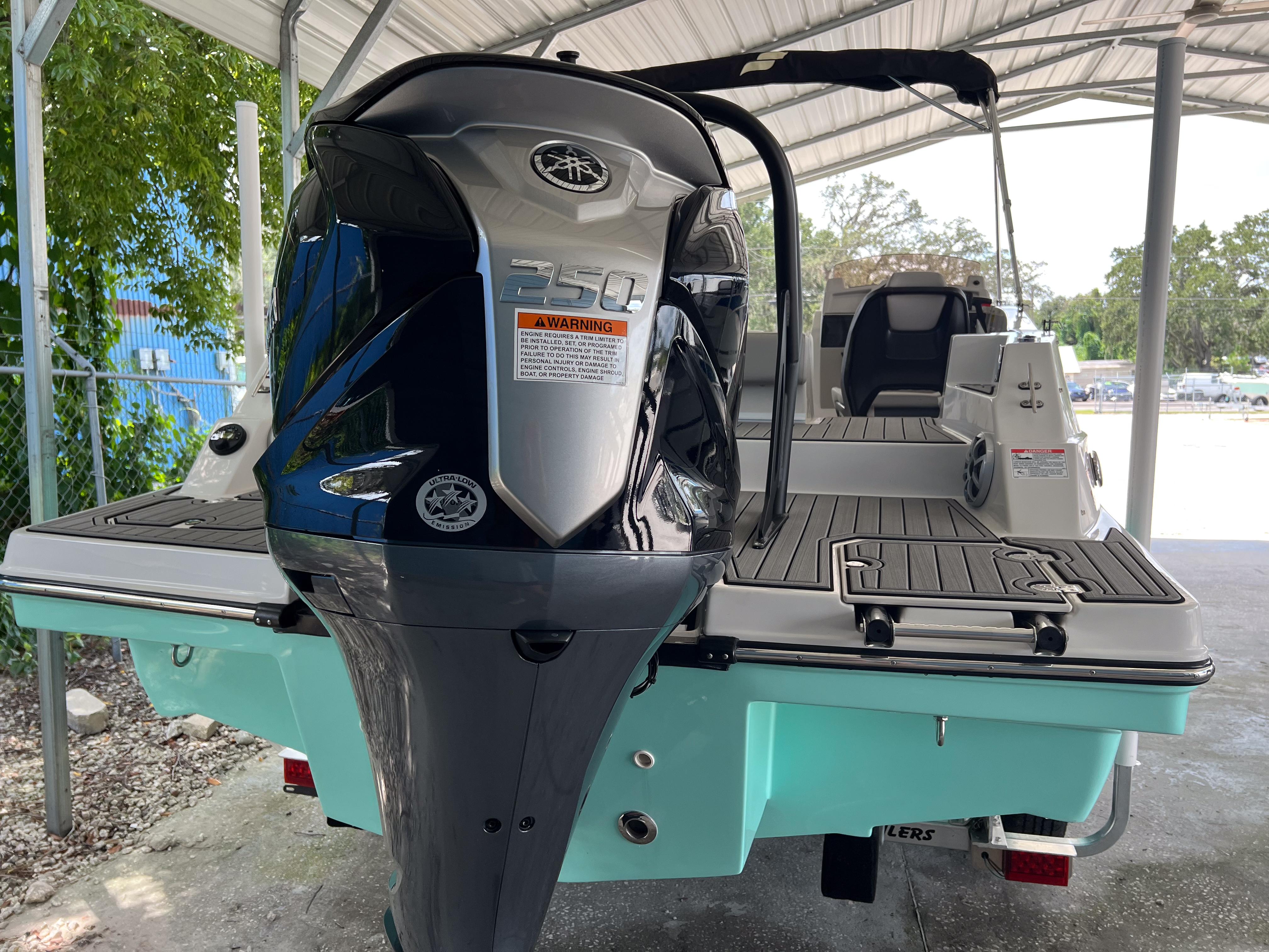 2026 Starcraft SVX 231 OB boat with powerful outboard motor, docked under a canopy.