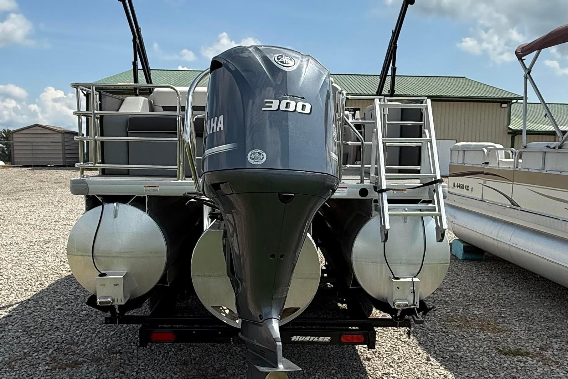 2022 Godfrey SWEETWATER 2486 pontoon boat with Yamaha 300 engine, parked outdoors.