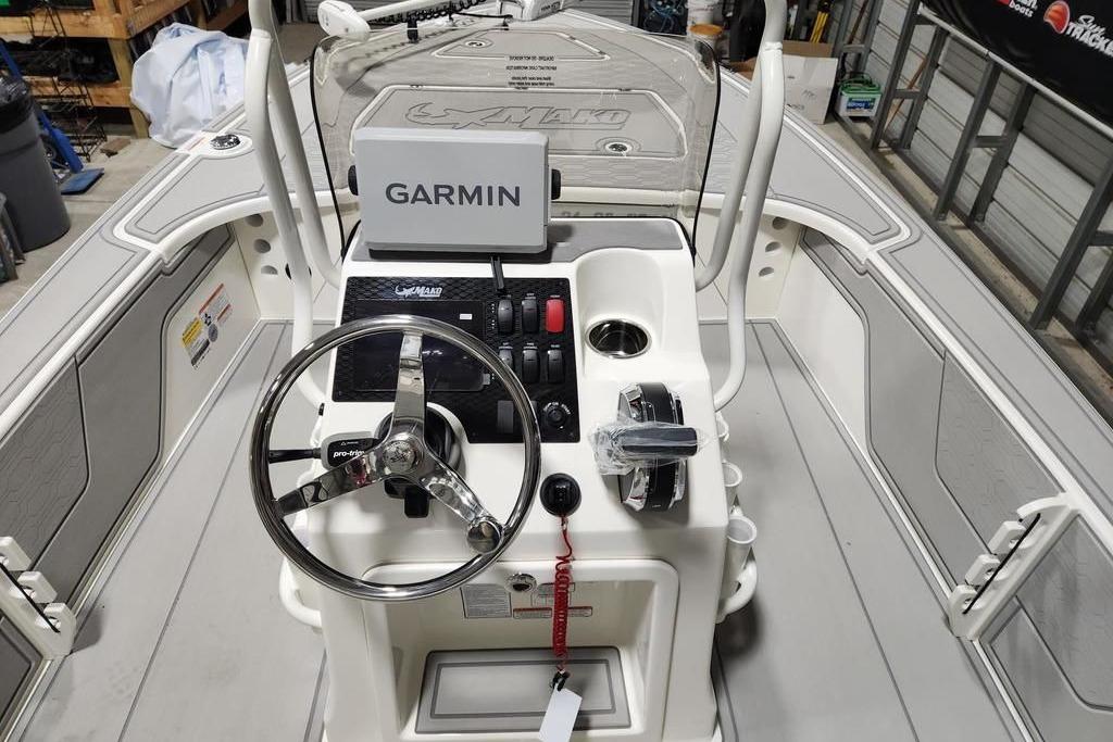 2026 Mako 18 Pro Skiff boat interior with Garmin navigation system and steering wheel.