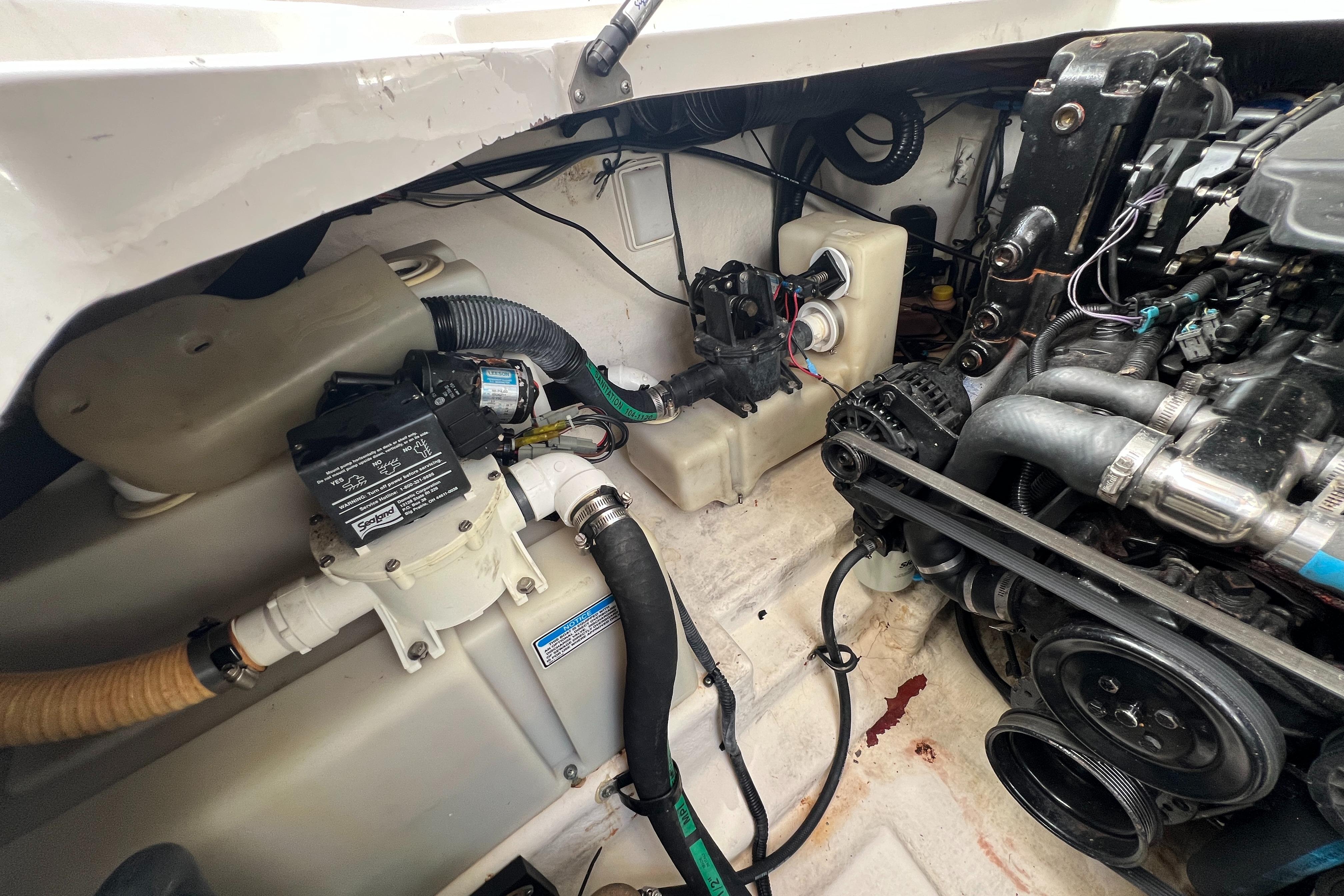Engine compartment of 2005 Sea Ray 280 Sundancer boat, showcasing mechanical components.
