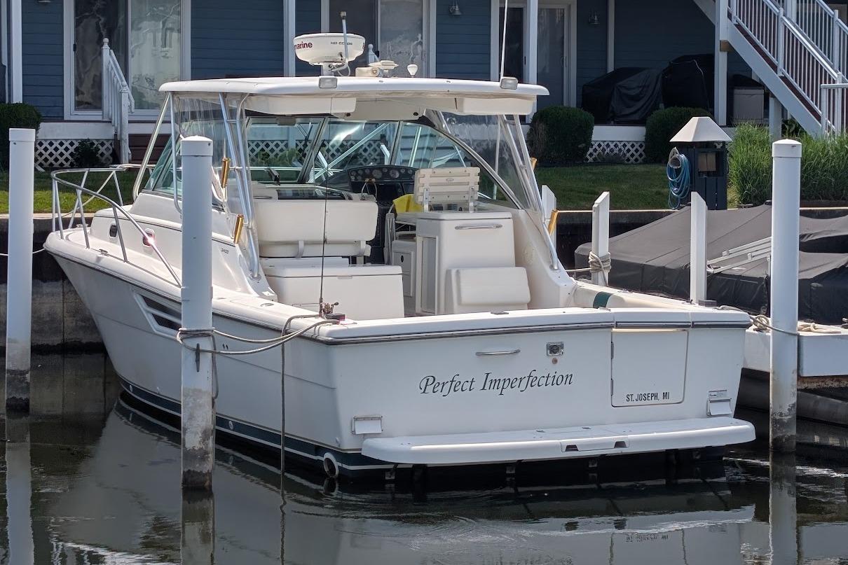 2000 Pursuit 3400 Express boat docked, named "Perfect Imperfection," in a marina setting.