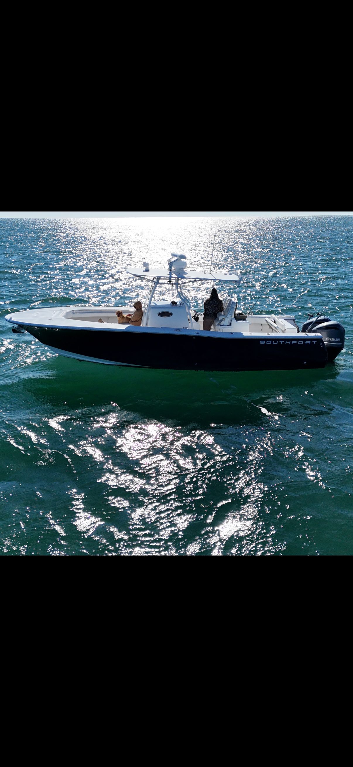 A 2014 Southport 29 Center Console boat cruising on calm waters.
