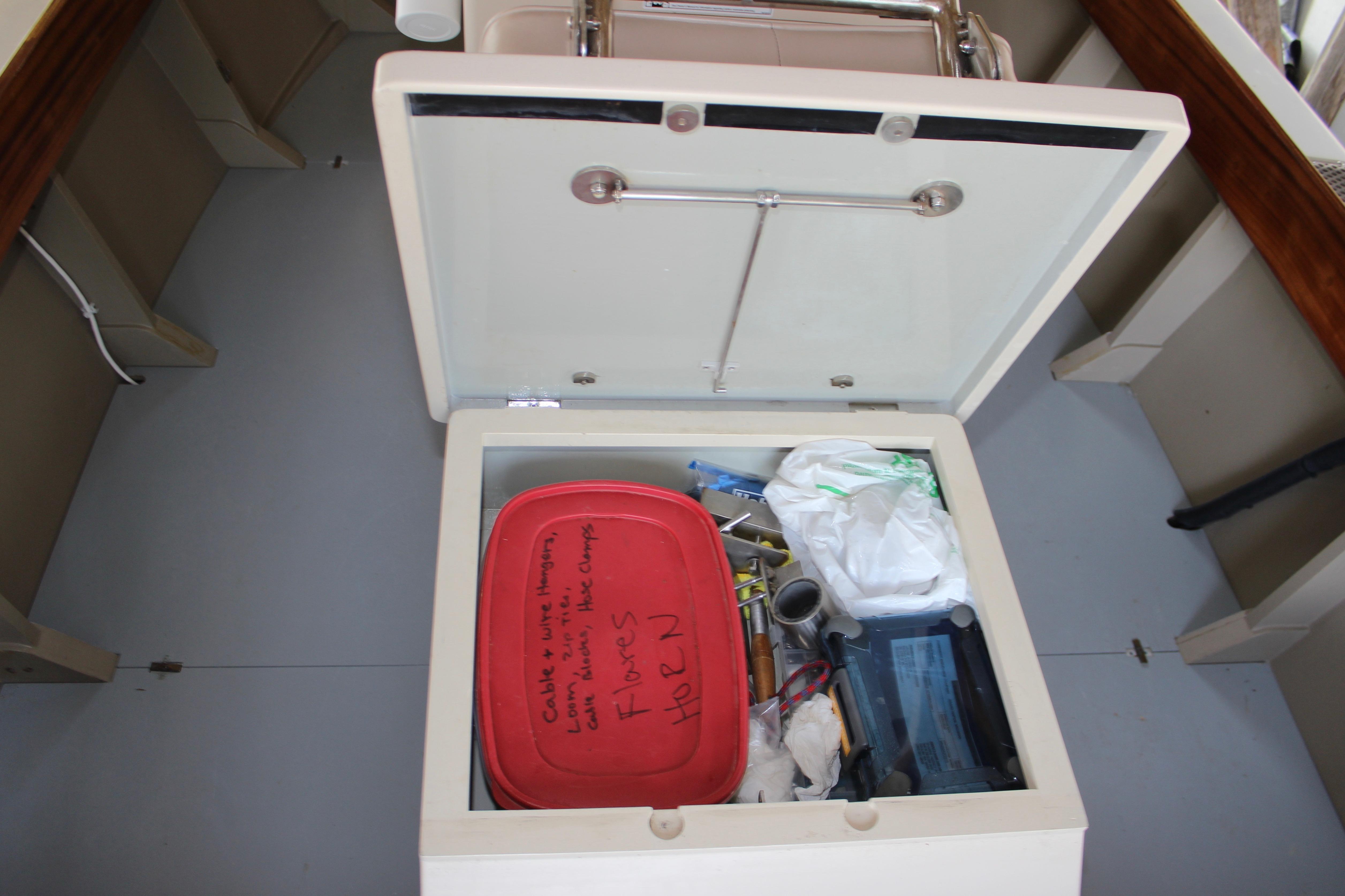 Storage compartment on a 2015 Custom Stambaugh Redwing 18' boat with tools and supplies.