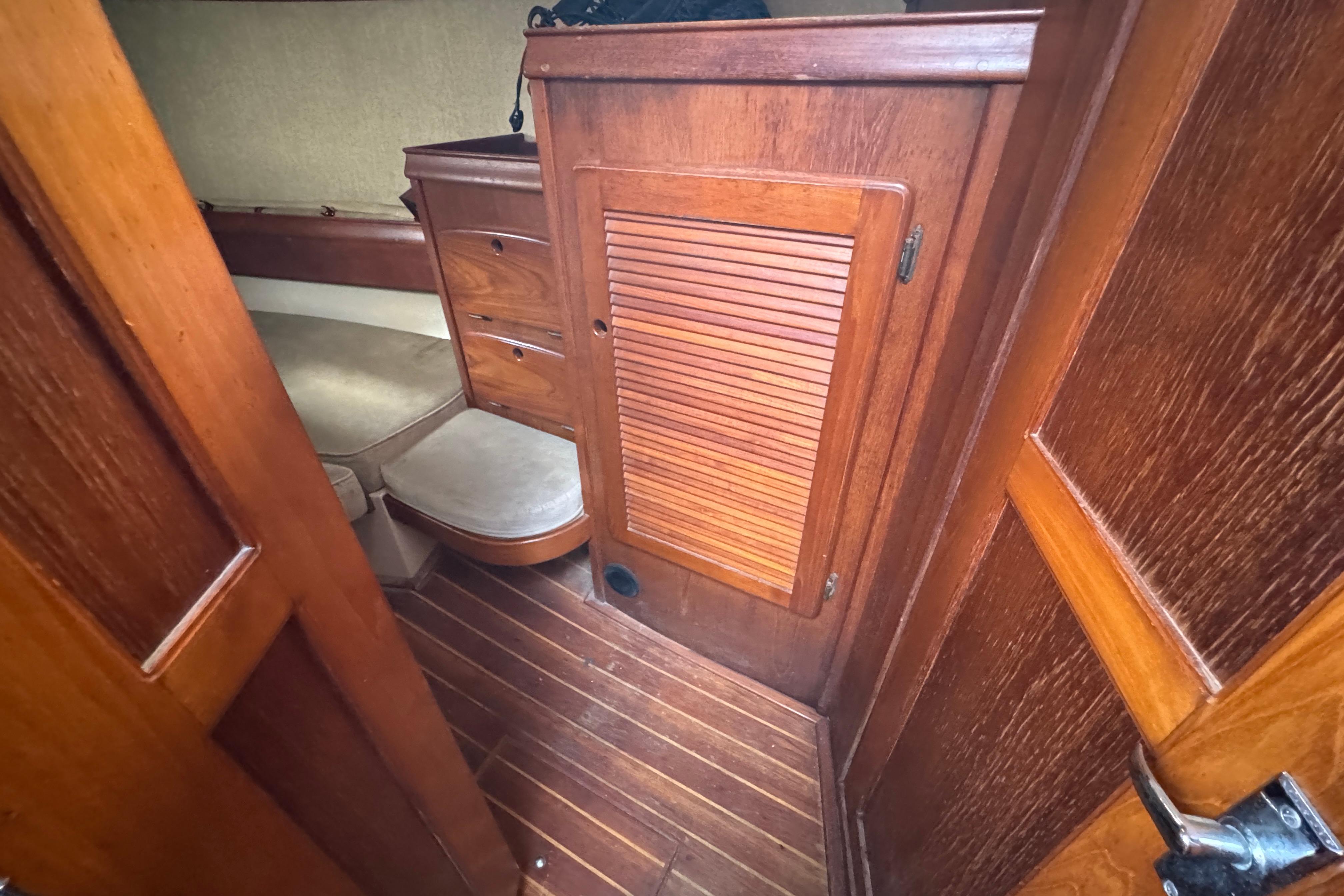 Interior cabin of 1991 Island Packet Yachts 38, featuring wooden cabinetry and seating.