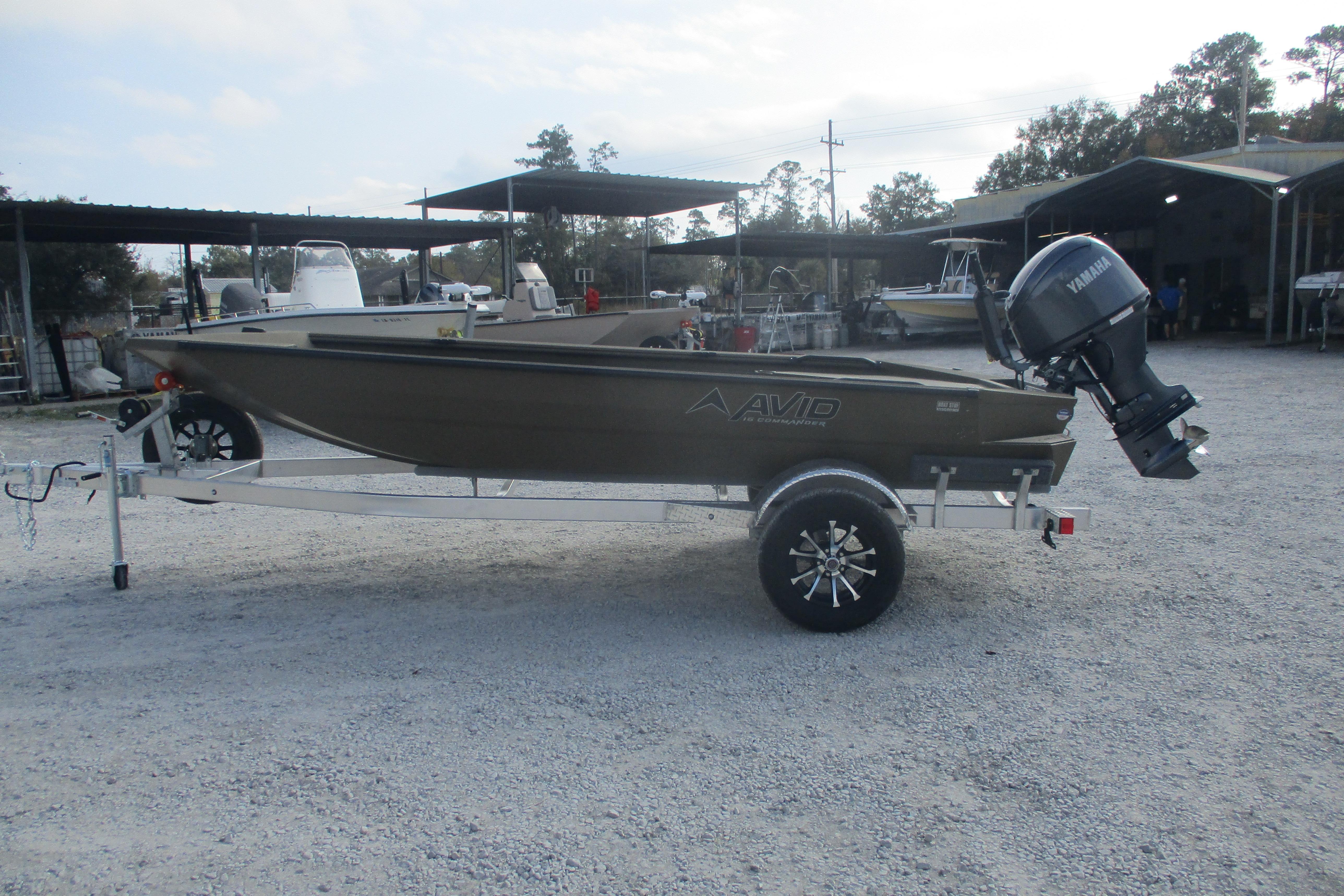 2026 Avid 16 Commander boat on trailer with Yamaha outboard motor in a gravel lot.