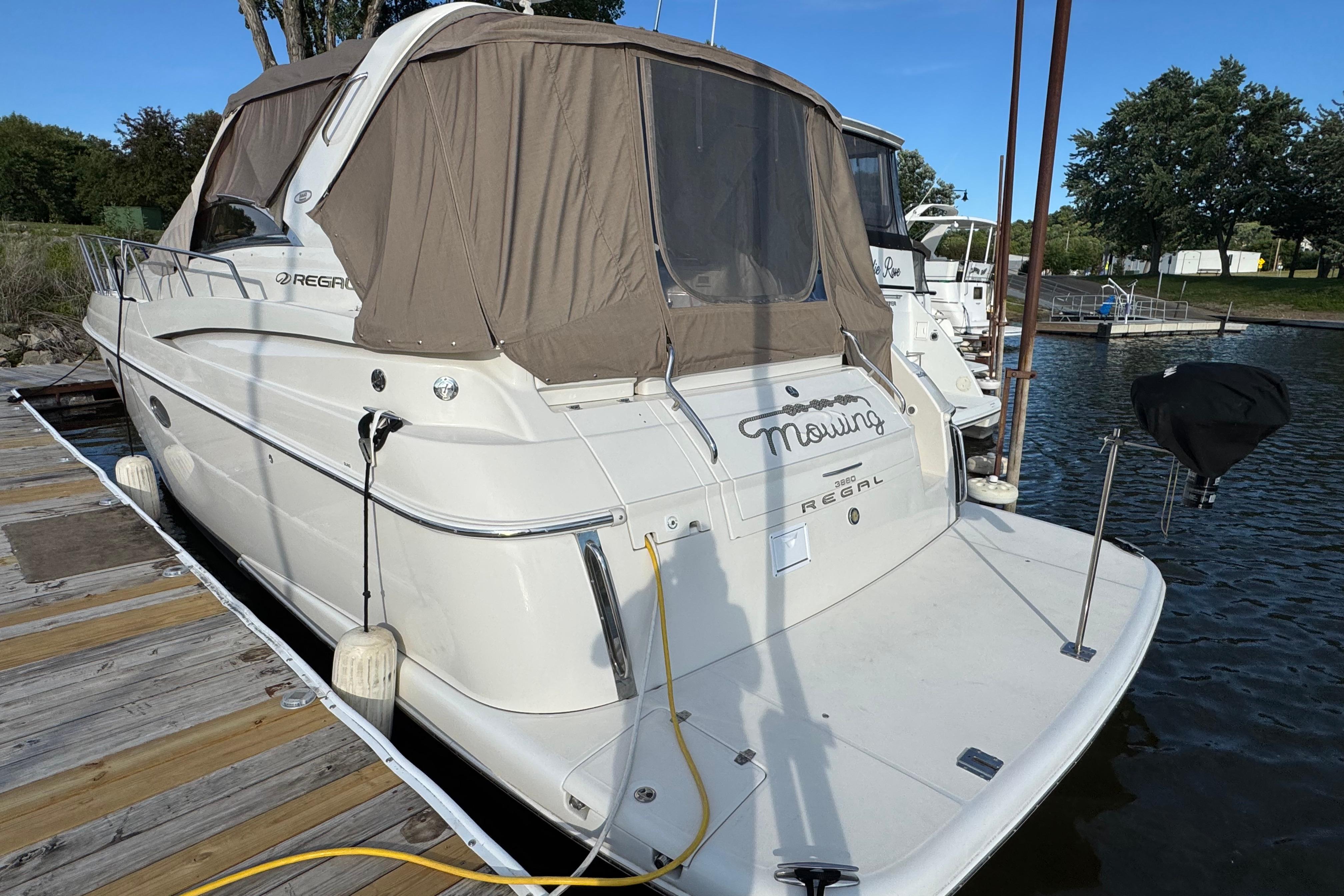 2007 Regal Commodore 3860 yacht docked at marina with beige canopy.