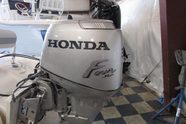 Honda Four-Stroke outboard motor on 2000 Zodiac Yachtline 340DL boat in garage setting.