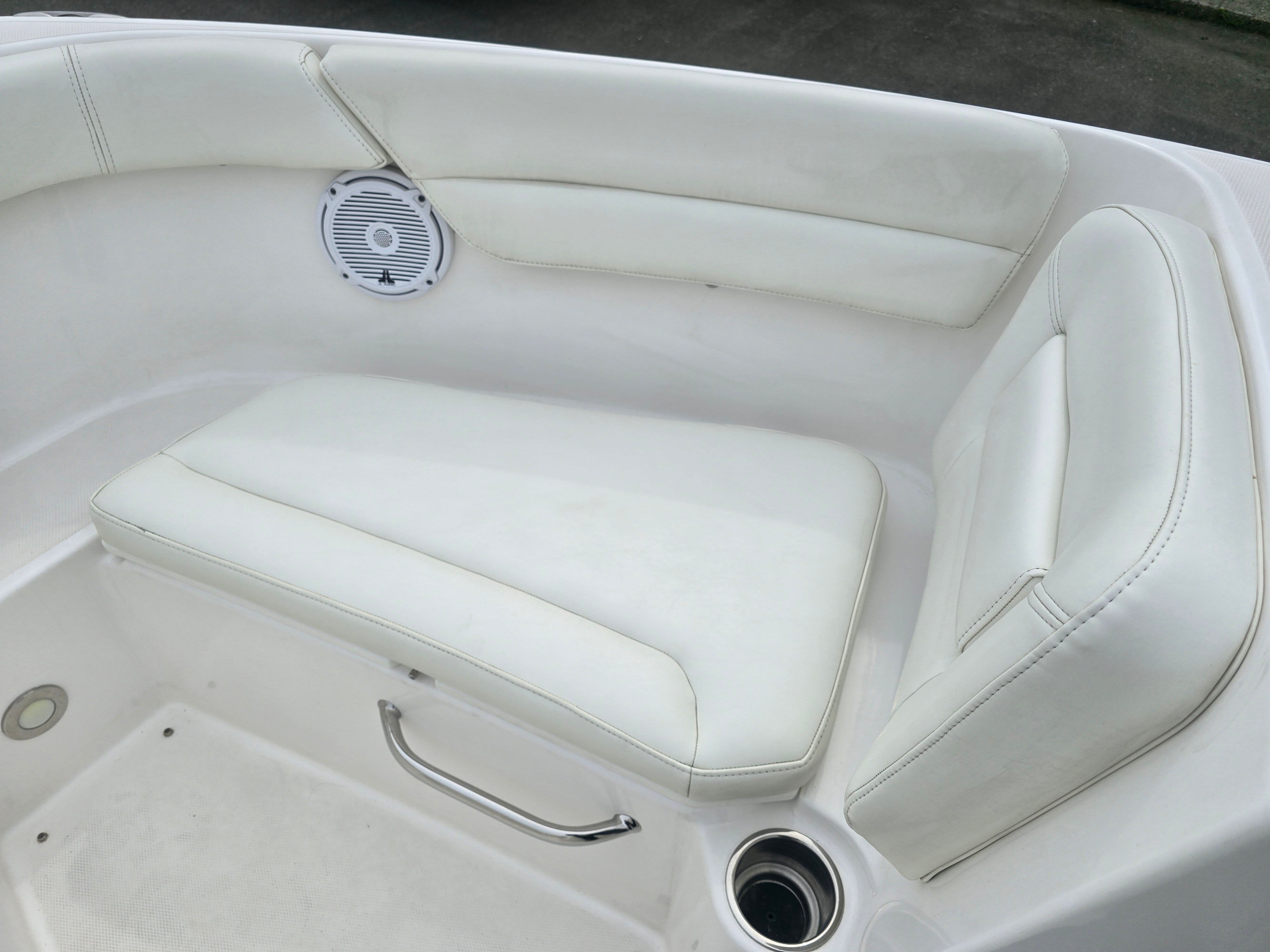 Everglades 230 Dual Console 2017: White cushioned seating area with speaker and cup holder.