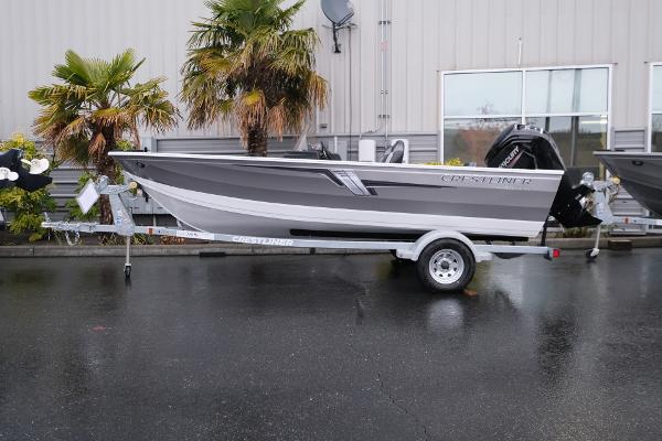2024 Crestliner 1600 Vision boat on trailer, parked outdoors near palm trees.