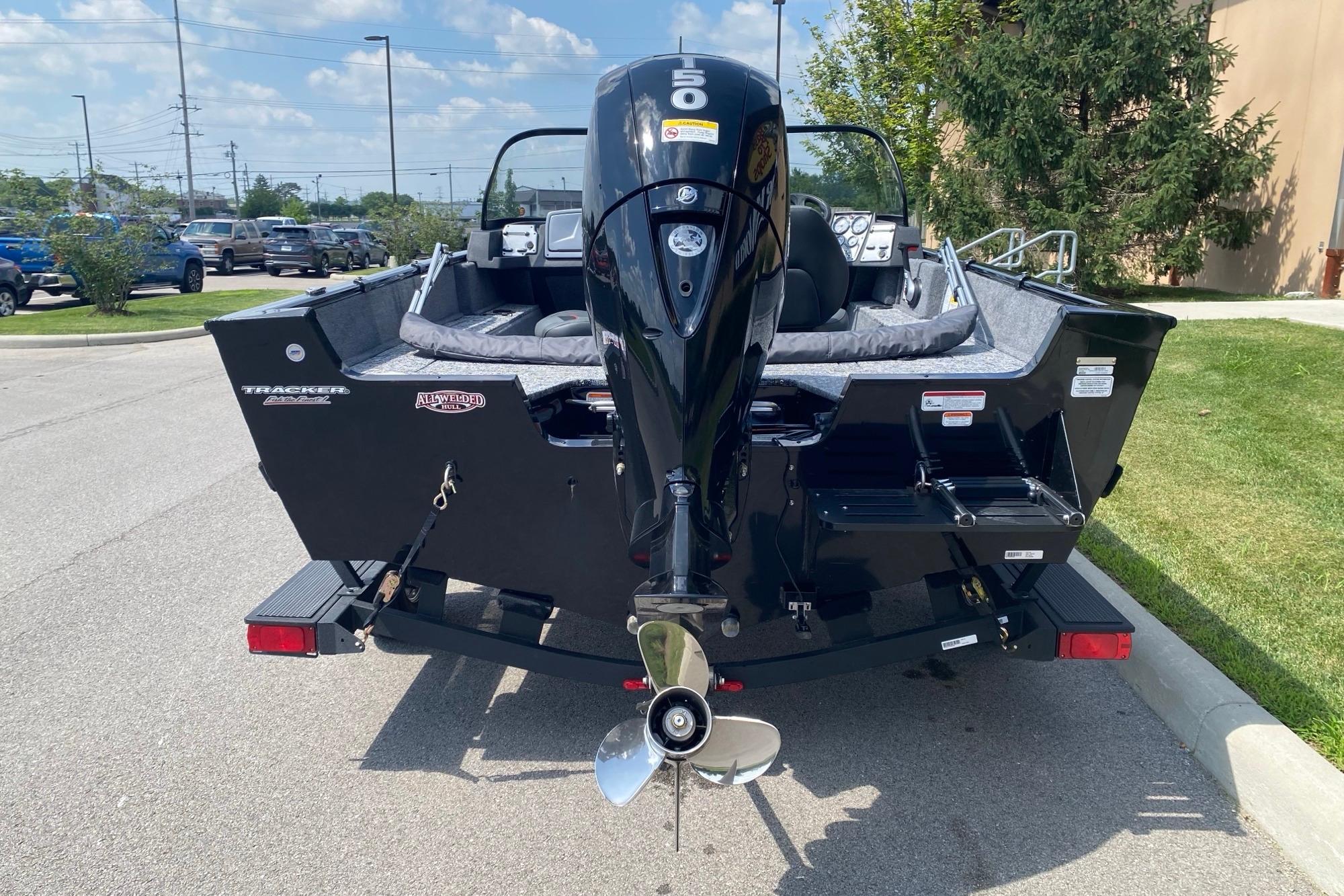 2026 Tracker Pro Guide V-175 Combo boat with powerful outboard motor, parked outdoors.