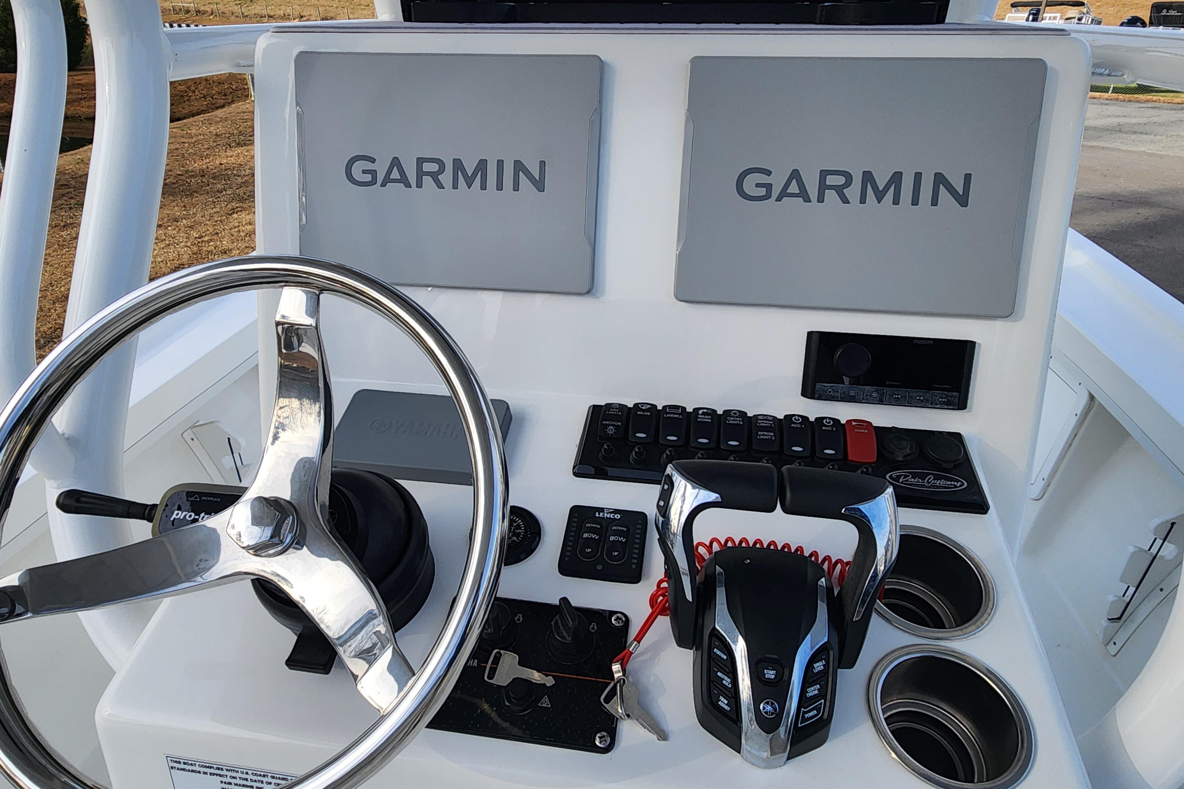2024 Pair Customs 27 CC boat dashboard with Garmin displays and steering wheel.