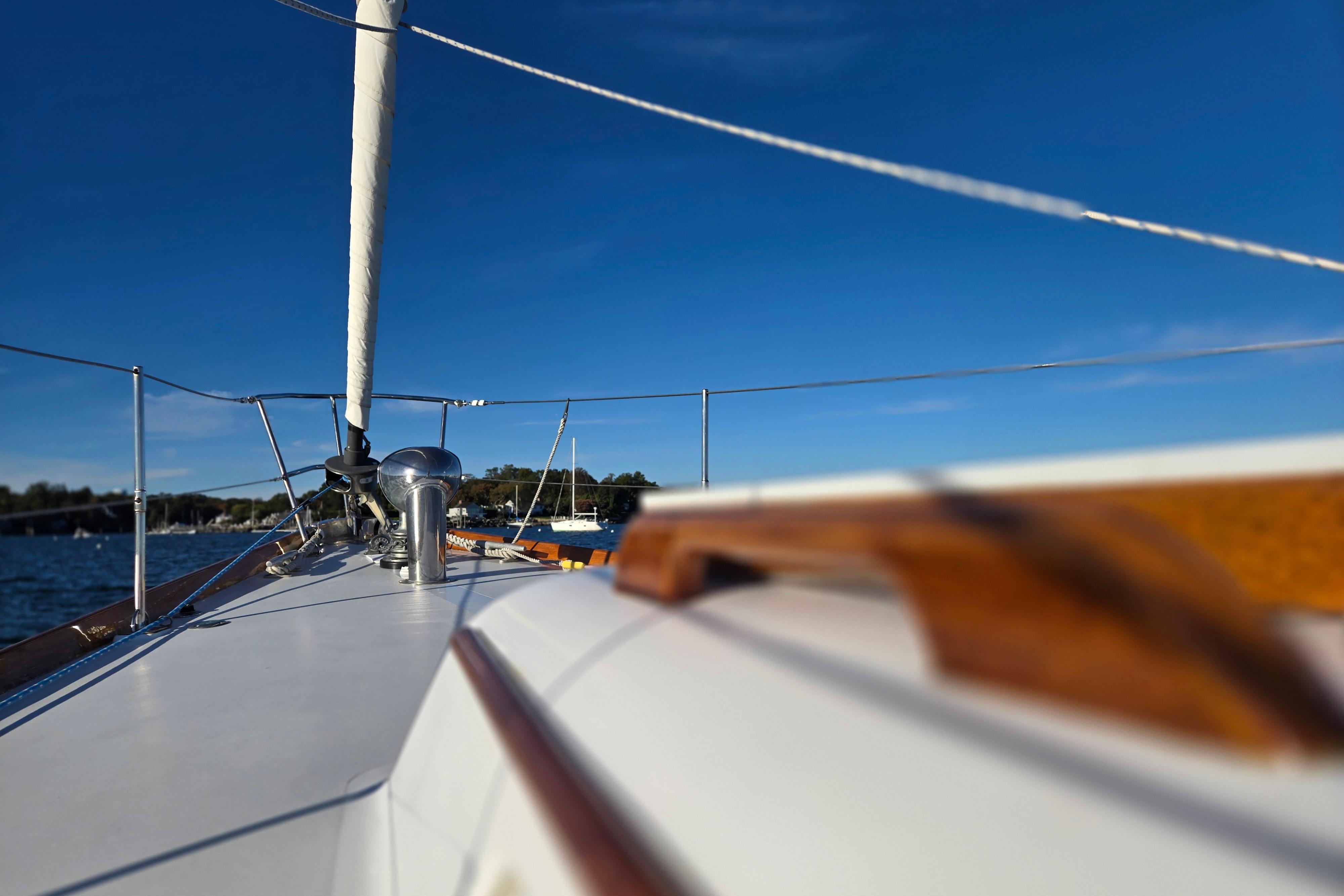 1970 Hinckley Bermuda 40 sailboat deck with clear blue sky background.