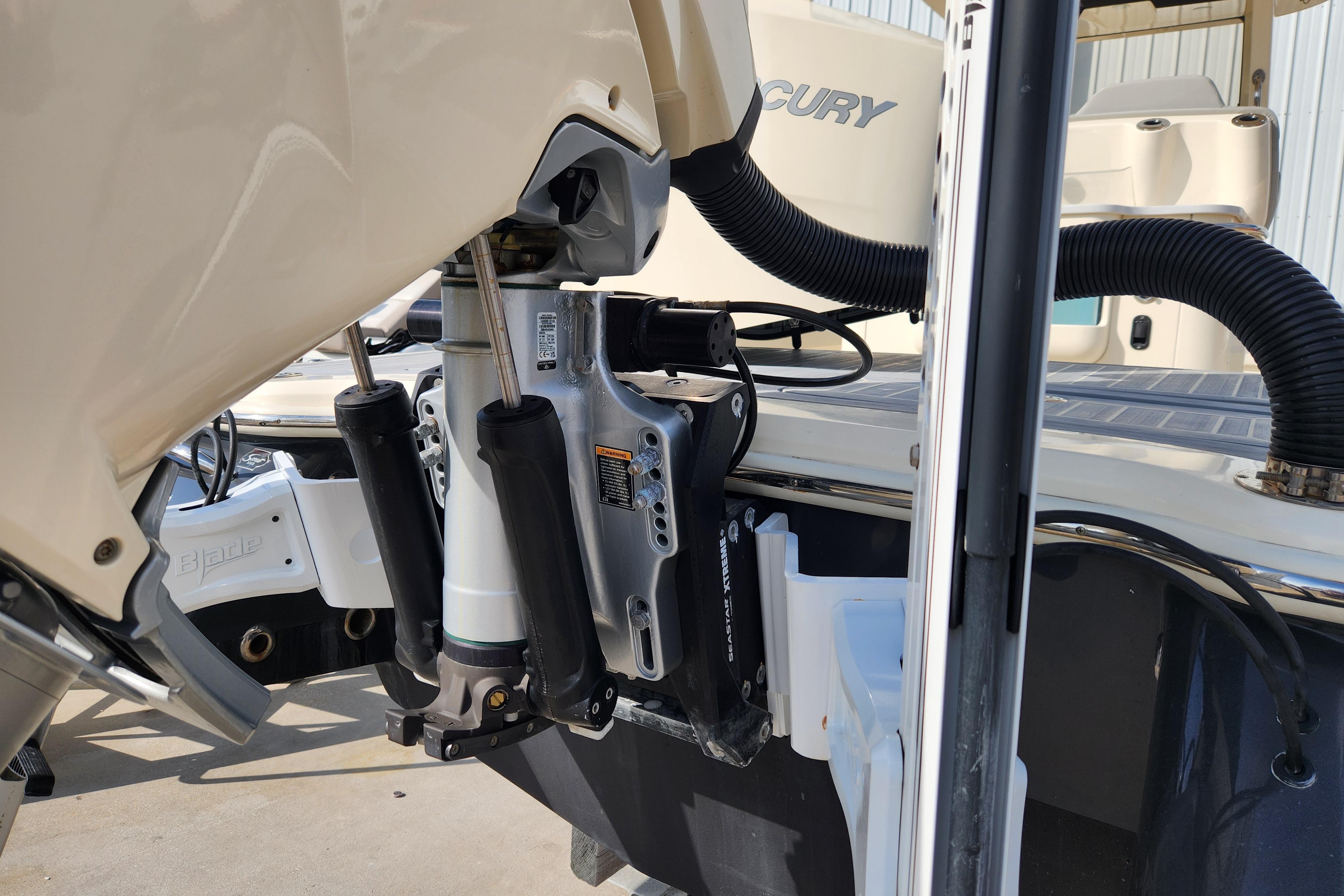 Close-up of 2024 Scout 281 XSS boat engine and hydraulic system.