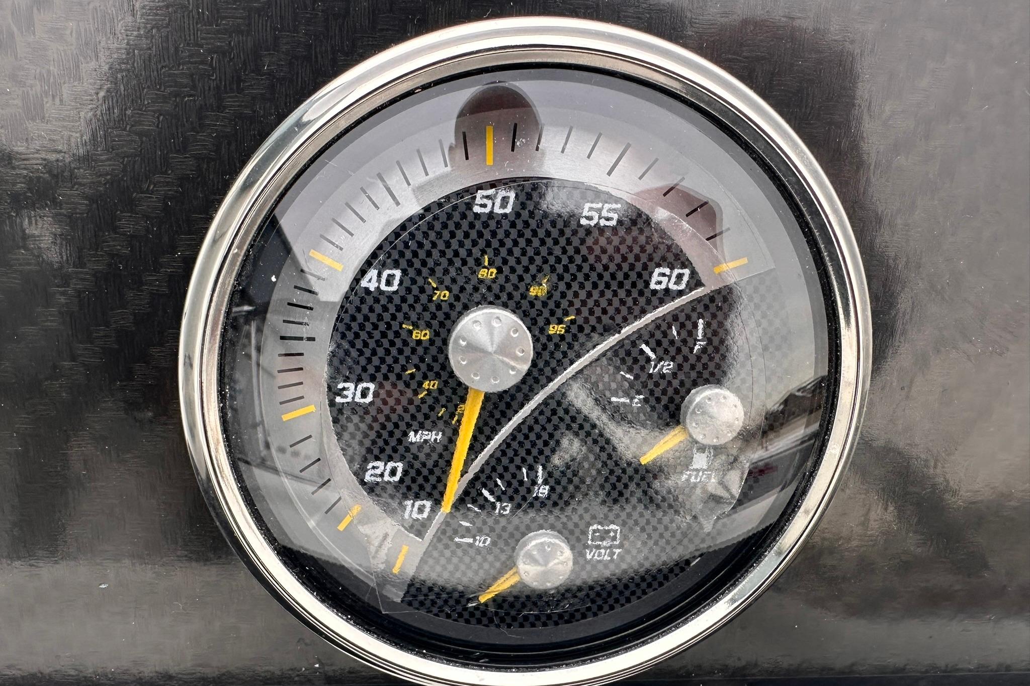 Close-up of 2026 Bayliner M17 speedometer with carbon fiber design.
