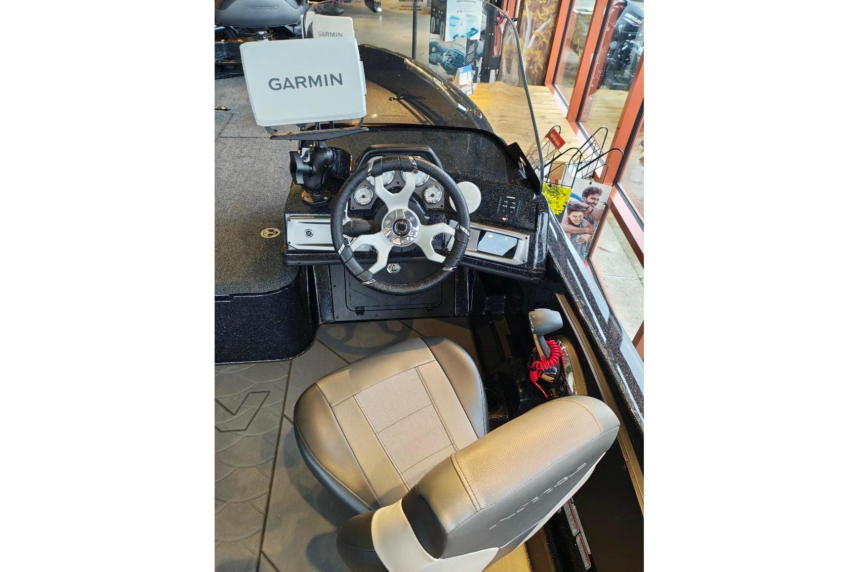Interior of 2026 Nitro ZV21 boat with Garmin navigation system and steering wheel.