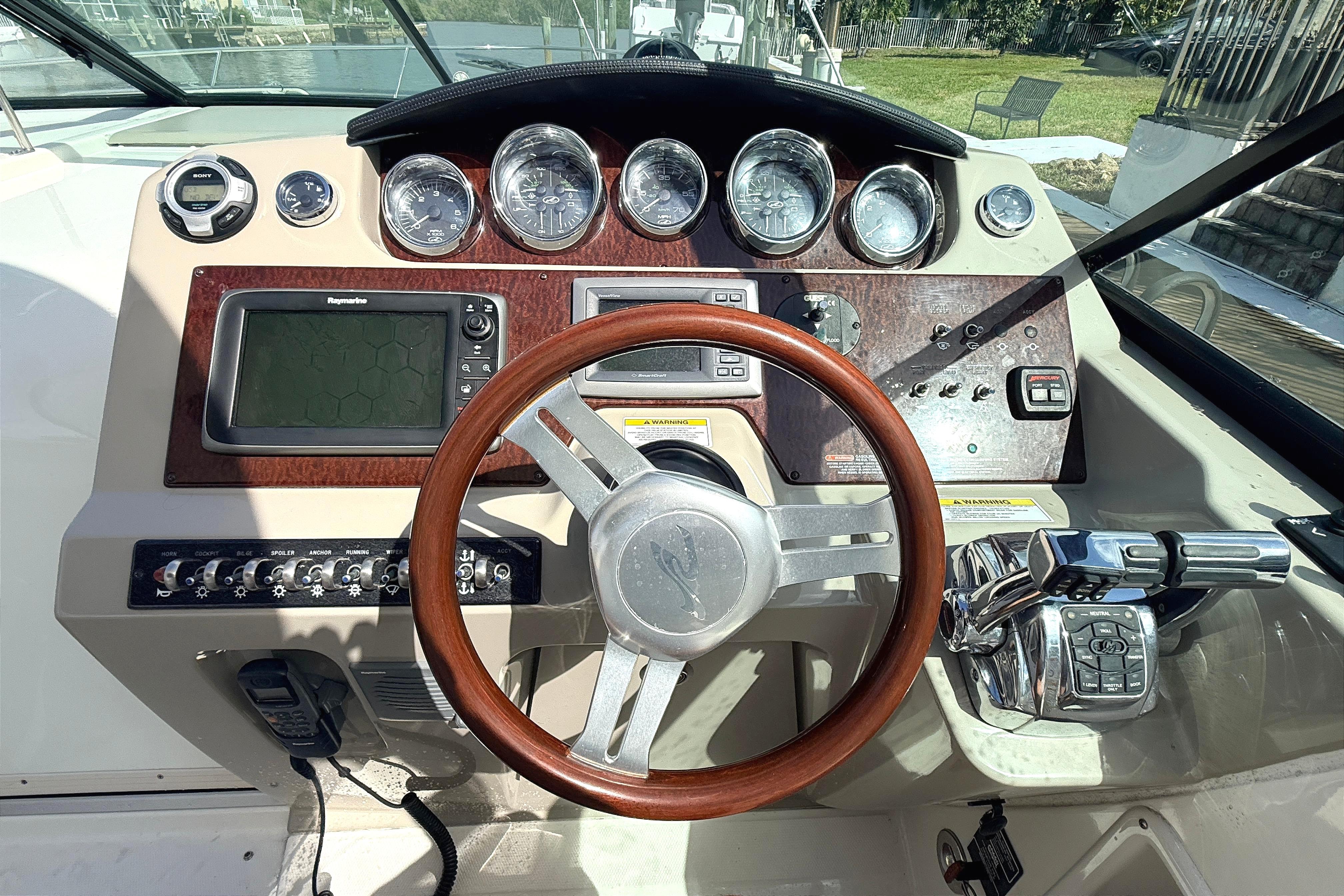 Cockpit of 2013 Sea Ray 370 Venture with steering wheel and control panel.