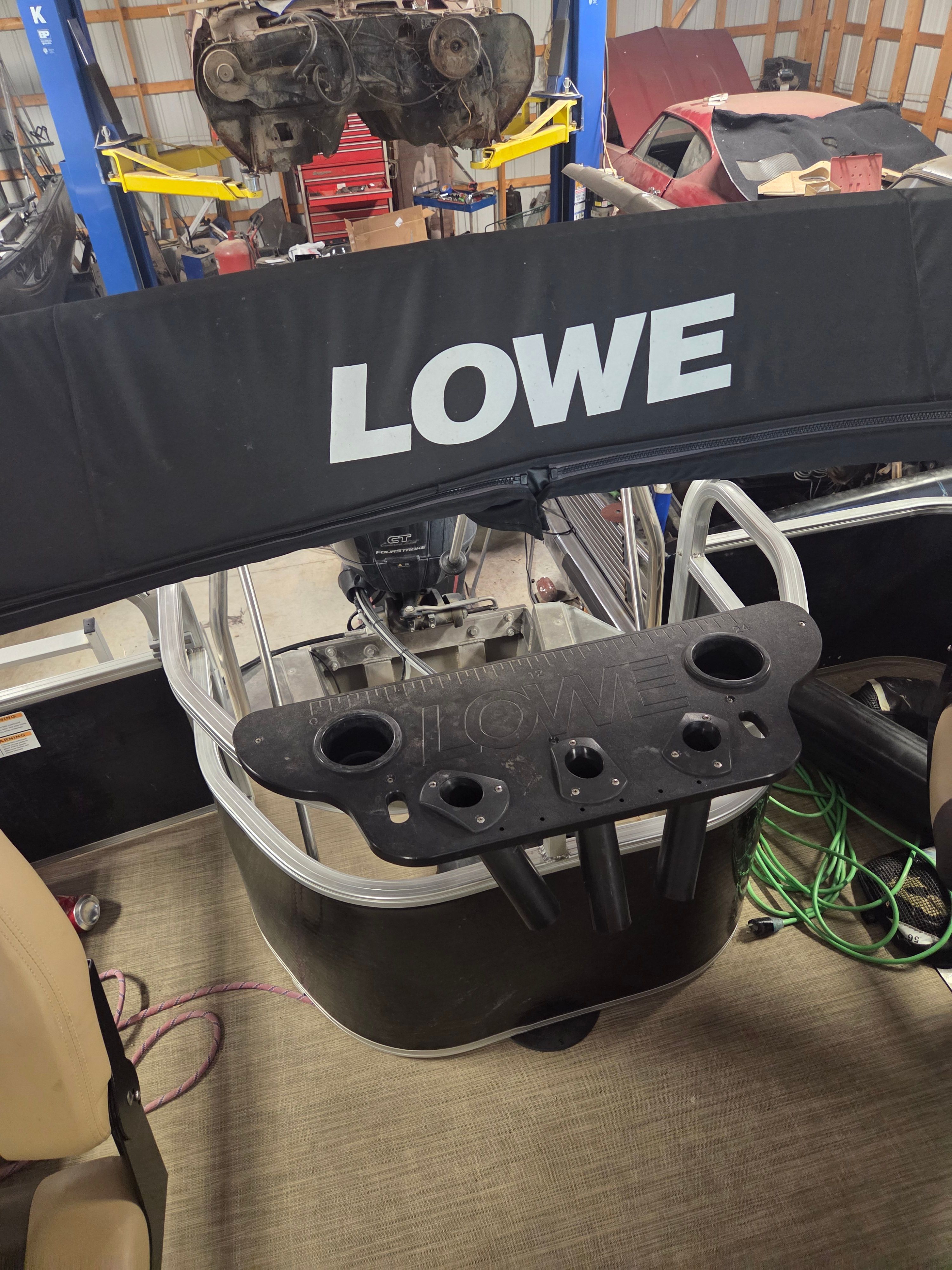 A 2017 Lowe SF 214 Sport Fish boat in a workshop.