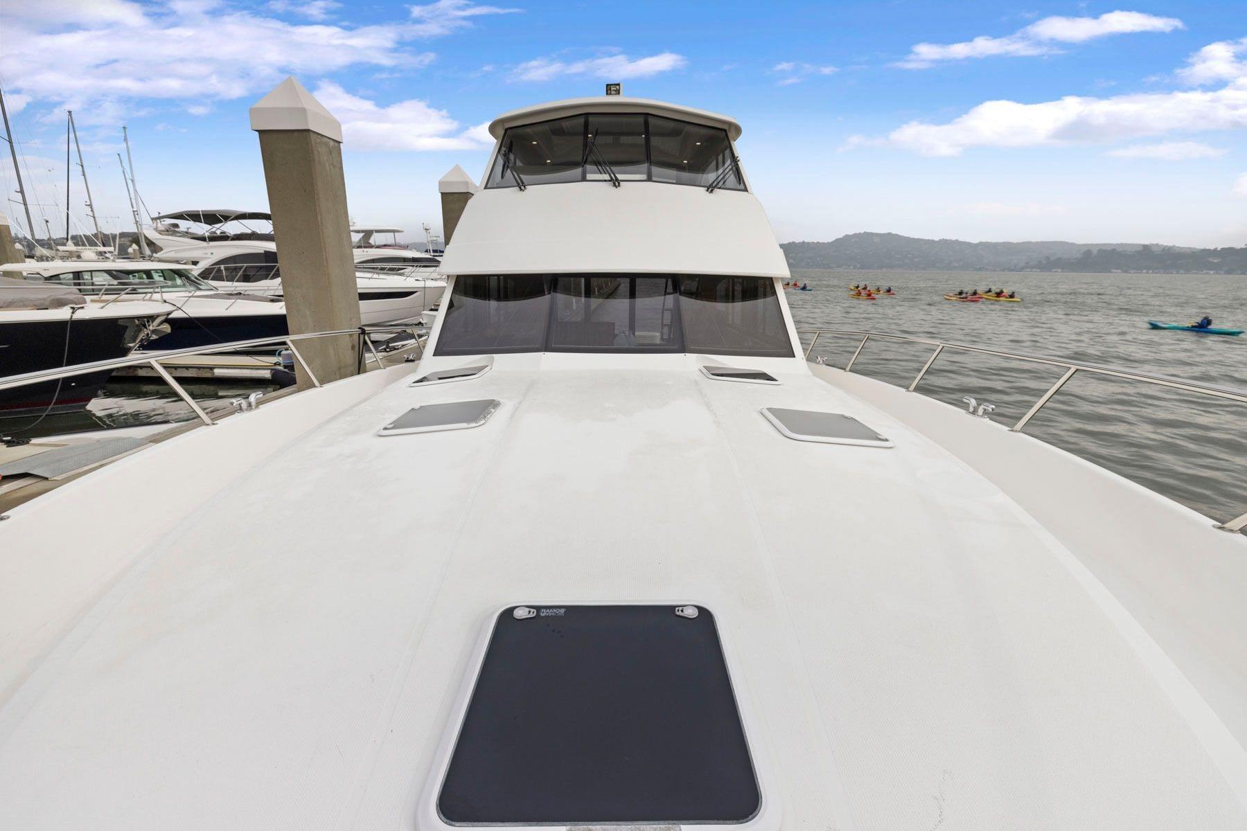 2014 Maritimo M50 yacht docked at marina with scenic water view.