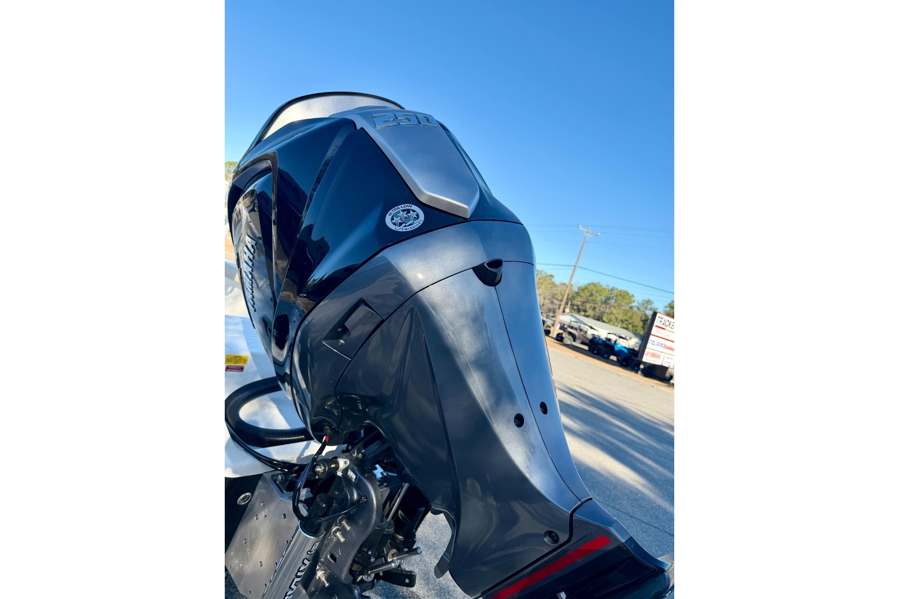 2026 Key West 210 Bay Reef boat engine, sleek design under clear blue sky.