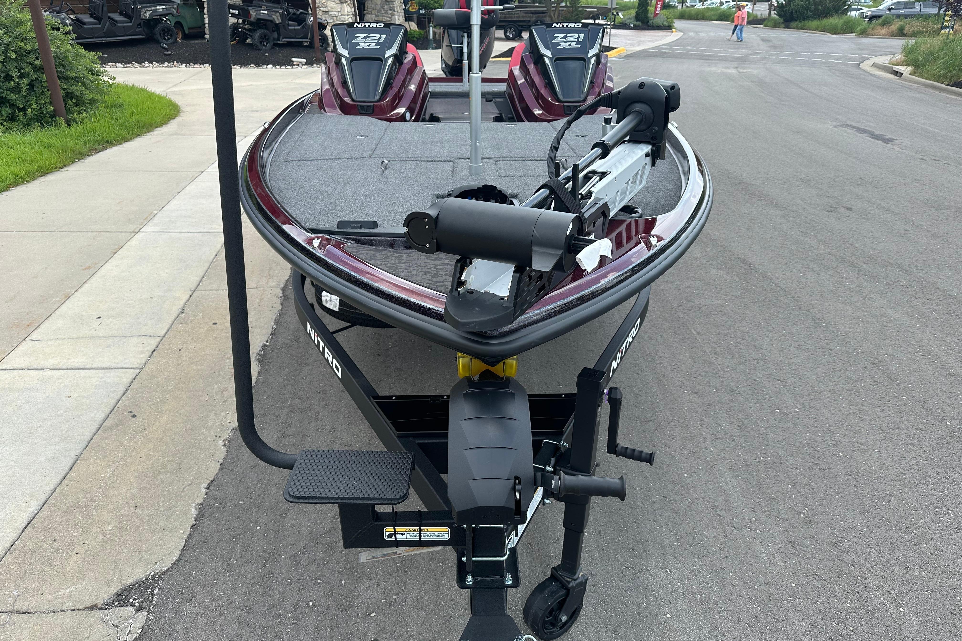 2026 Nitro Z21 XL boat on trailer, parked on a street.