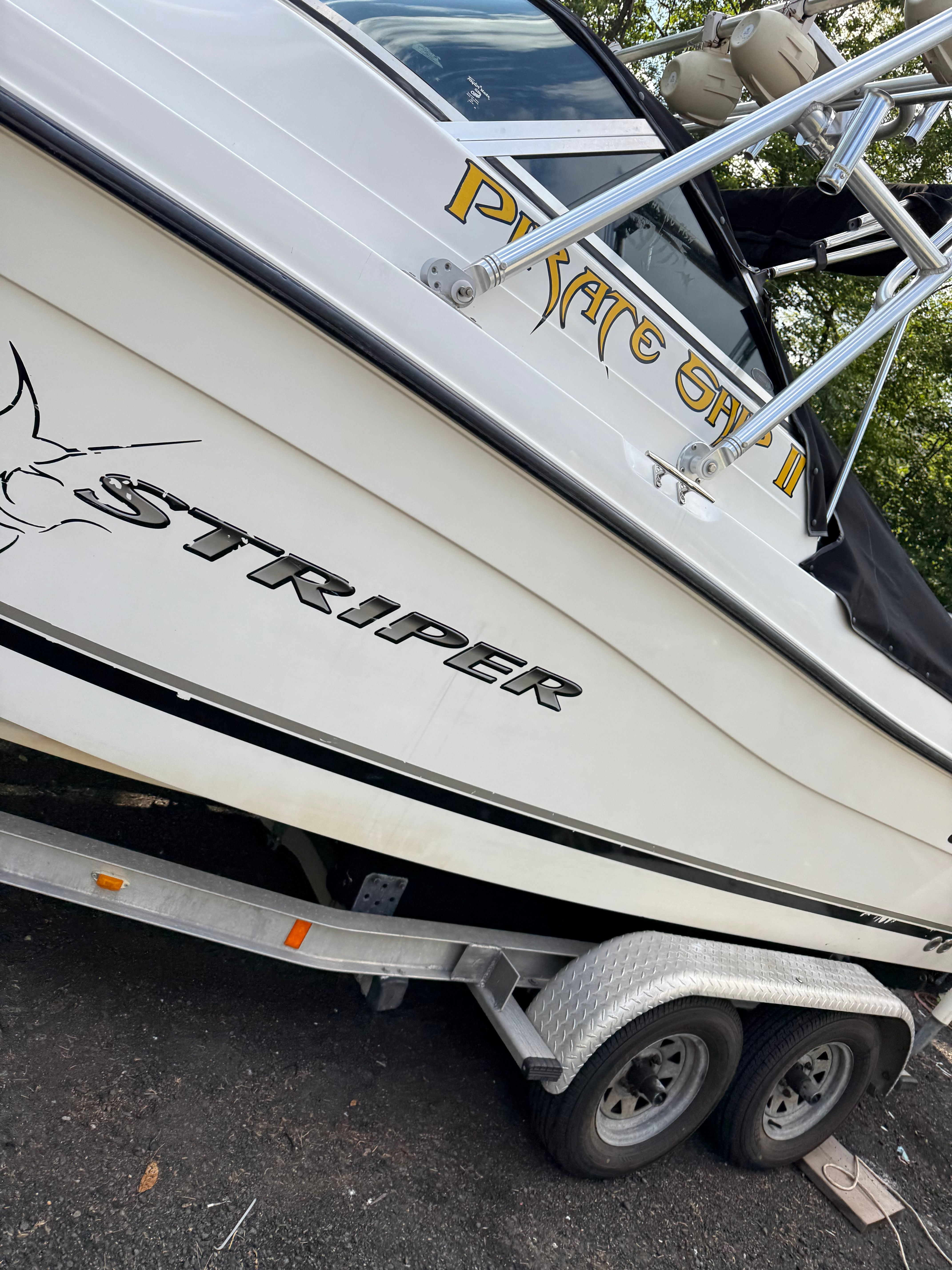 A 2002 Seaswirl Striper 2101 DC on a trailer, featuring bold lettering on the side.